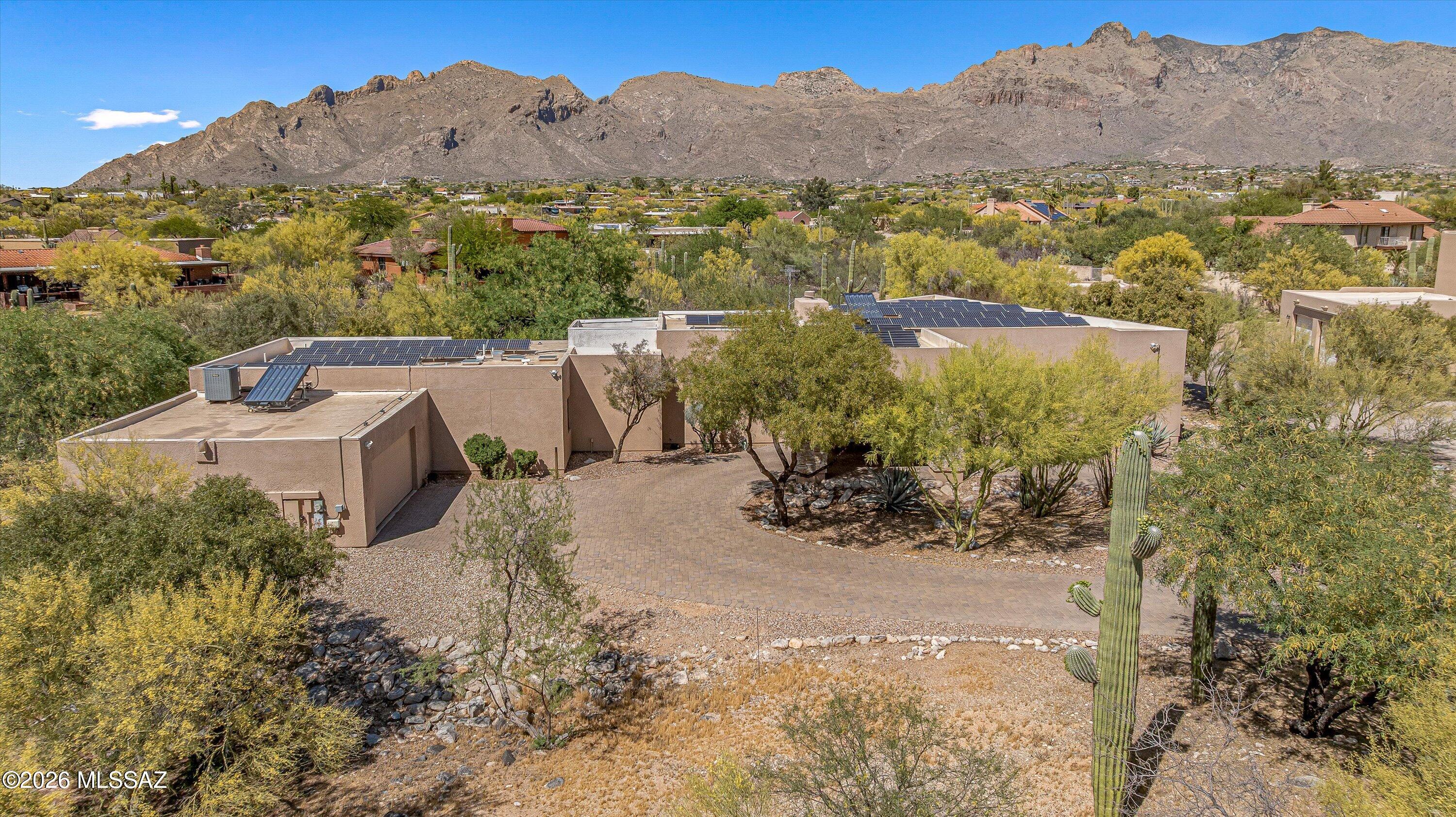 Located in the highly sought-after Shadow Hills community in the western Catalina Foothills, this exceptional residence offers the rare combination of expansive homesites, underground utilities, natural desert surroundings, and remarkably low annual HOA fees of just $96. Situated on a quiet cul-de-sac, the property enjoys stunning Catalina Mountain views that transform throughout the day, creating a breathtaking backdrop from sunrise to sunset.
Over the past four years, the home has undergone an extensive renovation, resulting in a beautifully updated 3,383-square-foot residence featuring 4 bedrooms and 4 bathrooms. Major improvements include a new 20-year roof, 15kW owned solar system, 21-SEER high-efficiency HVAC system, remodeled kitchen and bathrooms, updated flooring, newer appliances, and a low-maintenance fiberglass pool and spa. These significant upgrades provide modern comfort, energy efficiency, and reduced maintenance demands for future ownership.
Designed with flexibility in mind, the home features two spacious primary suites. The main primary retreat offers generous closet space in two separate areas and a luxurious spa-inspired bathroom. Multiple televisions throughout the home, including custom pop-up televisions in both primary suites and the primary bath, as well as televisions in the media/living room and dining/family room, are available to convey. Select patio furniture, outdoor furnishings, and yard sculptures may also be included. Buyers are encouraged to contact the listing agent for a complete list of items available to convey with the property.
The property has been thoughtfully updated with features that support ease of ownership, including roll-down shutters, an installed alarm system, owned solar, and numerous low-maintenance improvements throughout the home. Combined with newer major systems and extensively renovated interior and exterior spaces, the home offers a convenient and well-considered living experience designed to simplify day-to-day upkeep.
Offering a premier Foothills location, extensive renovations, energy-efficient upgrades, dual primary suites, spectacular Catalina Mountain views, and a variety of furnishings and electronics available to convey, this remarkable property presents an exceptional opportunity at its newly reduced price.