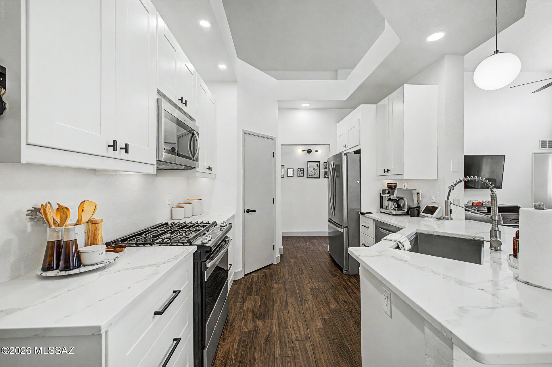 MOVE-IN READY in desirable Rita Ranch! This beautifully updated 4-bedroom home features soaring vaulted ceilings, wood-look flooring, contemporary lighting, and a bright open layout. The remodeled kitchen shines with white shaker cabinets, quartz countertops, and modern finishes perfect for everyday living and entertaining. The spacious primary suite offers dual vanities and a walk-in closet, while the additional bedrooms provide flexibility for family, guests, or a home office. Located in the highly sought-after Vail School District and just minutes from shopping, dining, parks, and more. Don't miss this opportunity to make this stunning home yours! Gather with your loved ones in the backyard, complete with a covered patio ideal for morning coffee, a pergola, perfect for gatherings, and ample space for outdoor fun. What's not to love? Make it yours!