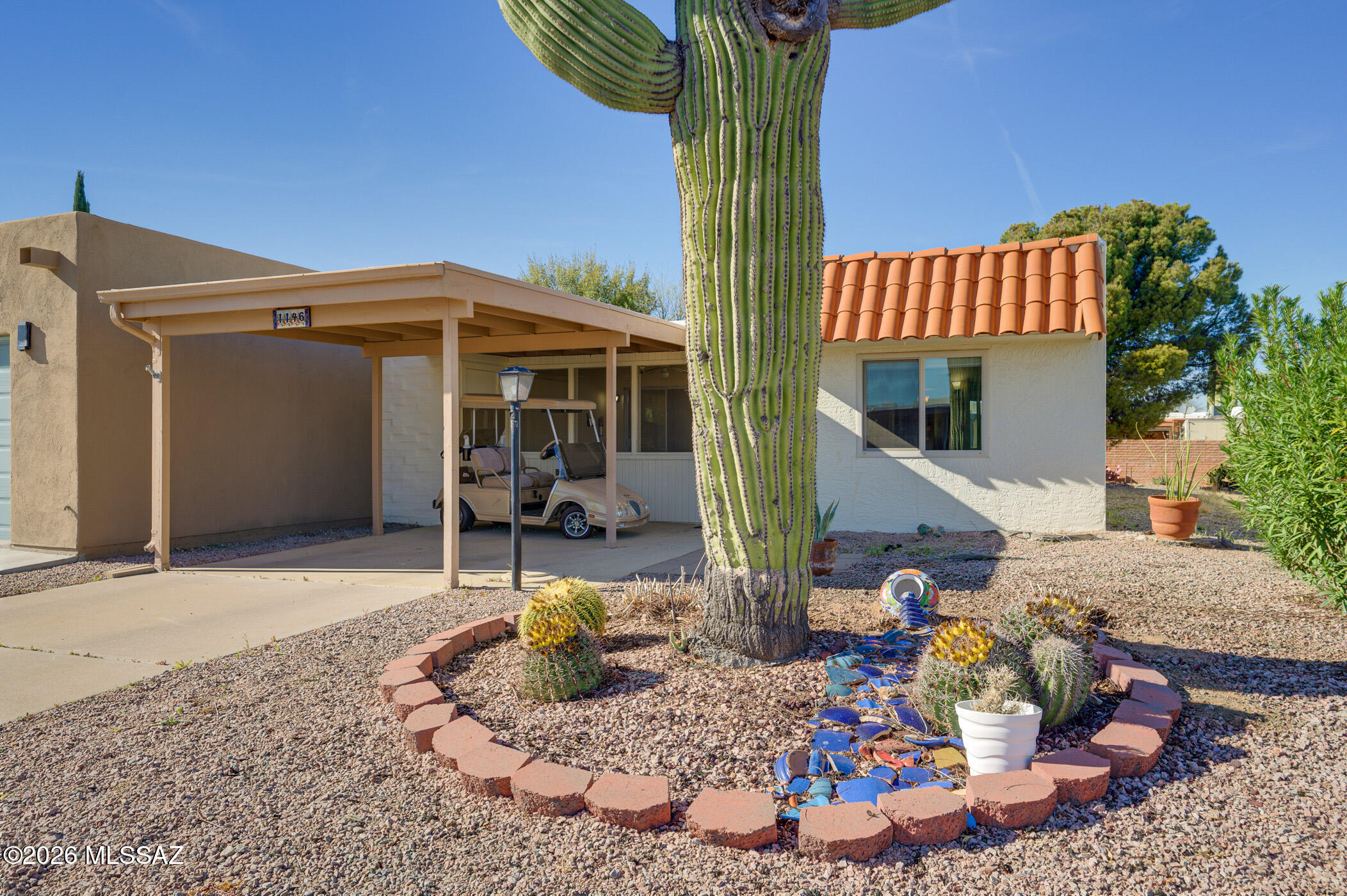 End unit in a quiet neighborhood. The south facing front screened porch is a perfect place to watch the sunrise over the Santa Rita Mountains while enjoying your morning coffee. Private rear covered patio opens to backyard with an orange tree and flower beds, backs to alley for plenty of space between rear neighbors. Close to shopping, Desert Meadows Park and Post Office.