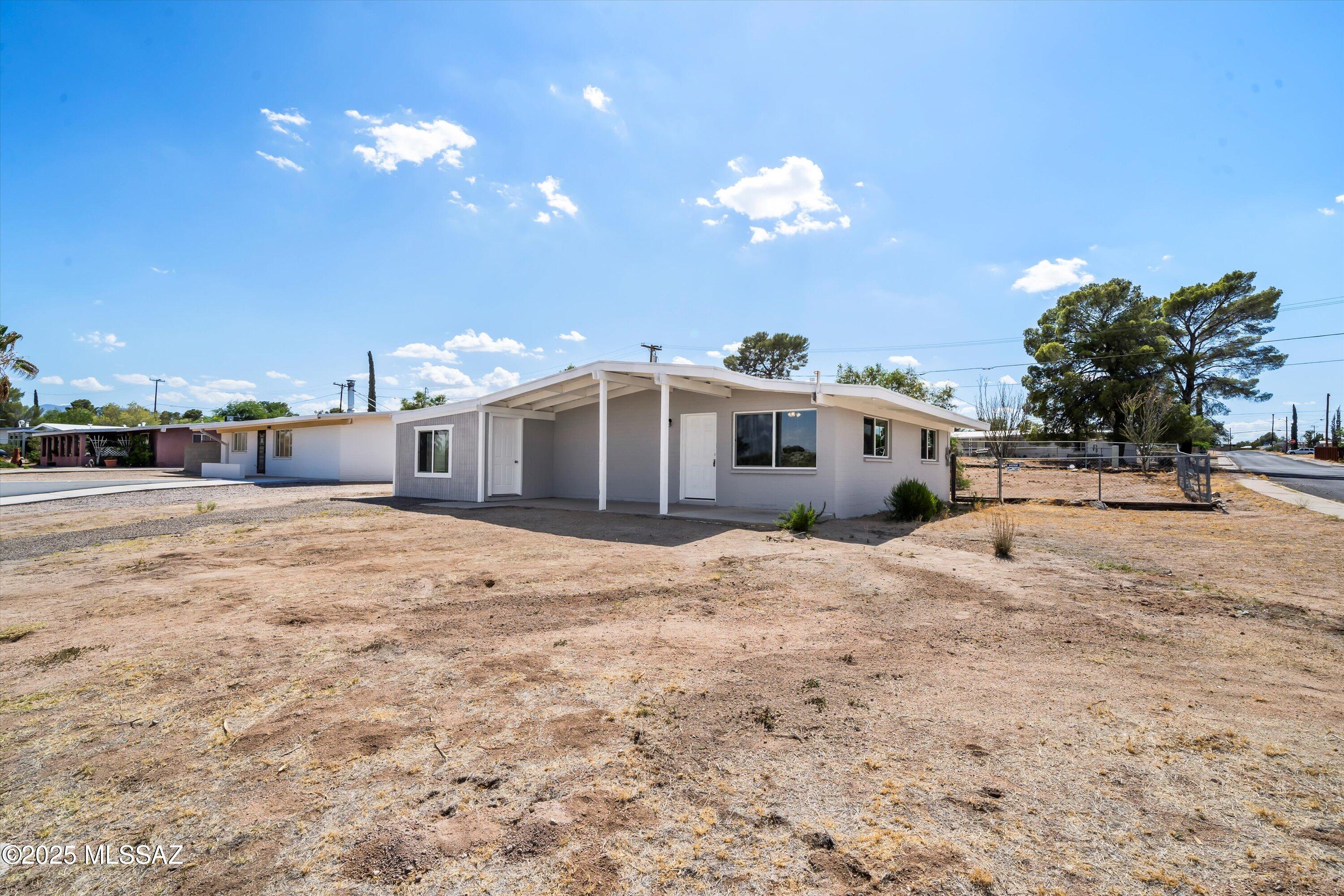 This completely remodeled 2-bed 1-bath home features an additional bonus room with AC, which can be used as a 3rd bedroom, home office, or play room.  Other upgrades include brand new central AC, stainless steel appliances, tile flooring throughout, new interior/exterior paint, dual pane windows, a large walk-in pantry, and interior laundry hook ups. The fully-fenced backyard features two storage sheds, and the large corner lot has nice mountain views! Owner pays the monthly sewer bill, but tenant pays all other utilities. Please contact property manager for rental application info and to schedule a showing. Rental will be available for Lease April 20, 2026.