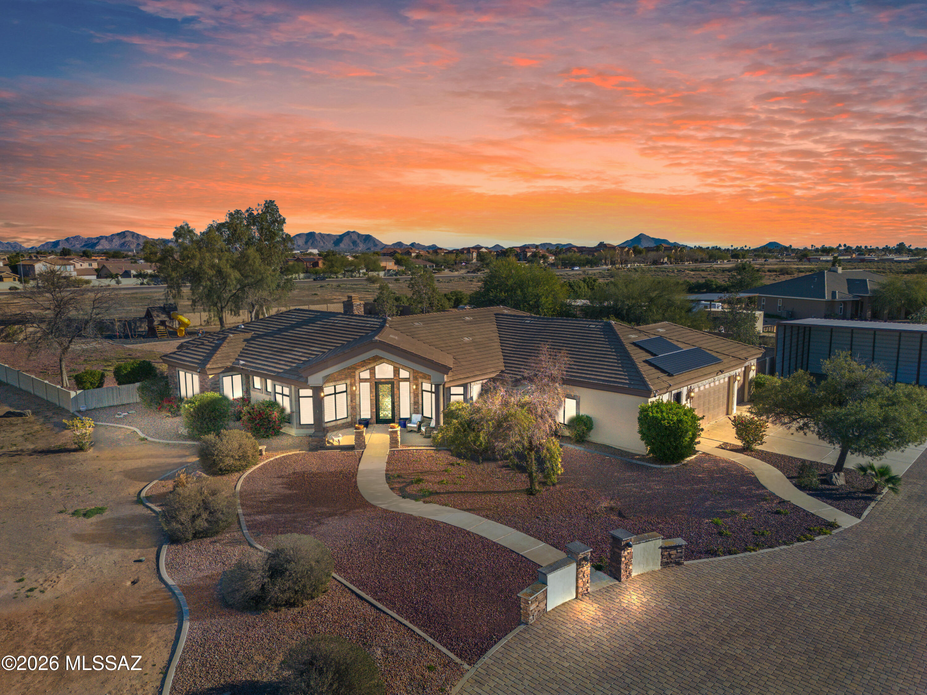 Back on market due to Buyer's Contingency falling through. Gorgeous 3,317 SQFT Home on 2.4 acres, featuring 4 bedrooms, 2.5 baths, and 2 versatile bonus flex rooms or offices. Refined stone and slate finishes frame a grand entry leading to double living and dining areas, a kitchen offering dual islands, high-end granite, and custom cabinetry. The oversized glass doors extend the great room to an expansive covered patio, spa, pergola kitchen & putting green. The primary suite includes French doors, a zero-entry dual shower, freestanding tub, and a custom walk-in closet. Additional features include surround sound, central vacuum, Culligan whole-home RO system, a 3-car garage with built-ins, a 4-stall carport, full RV hookups & dual automated gates. Zoned yes for horses. Every element in this home has been thoughtfully crafted with precision to elevate the experience of everyday living.