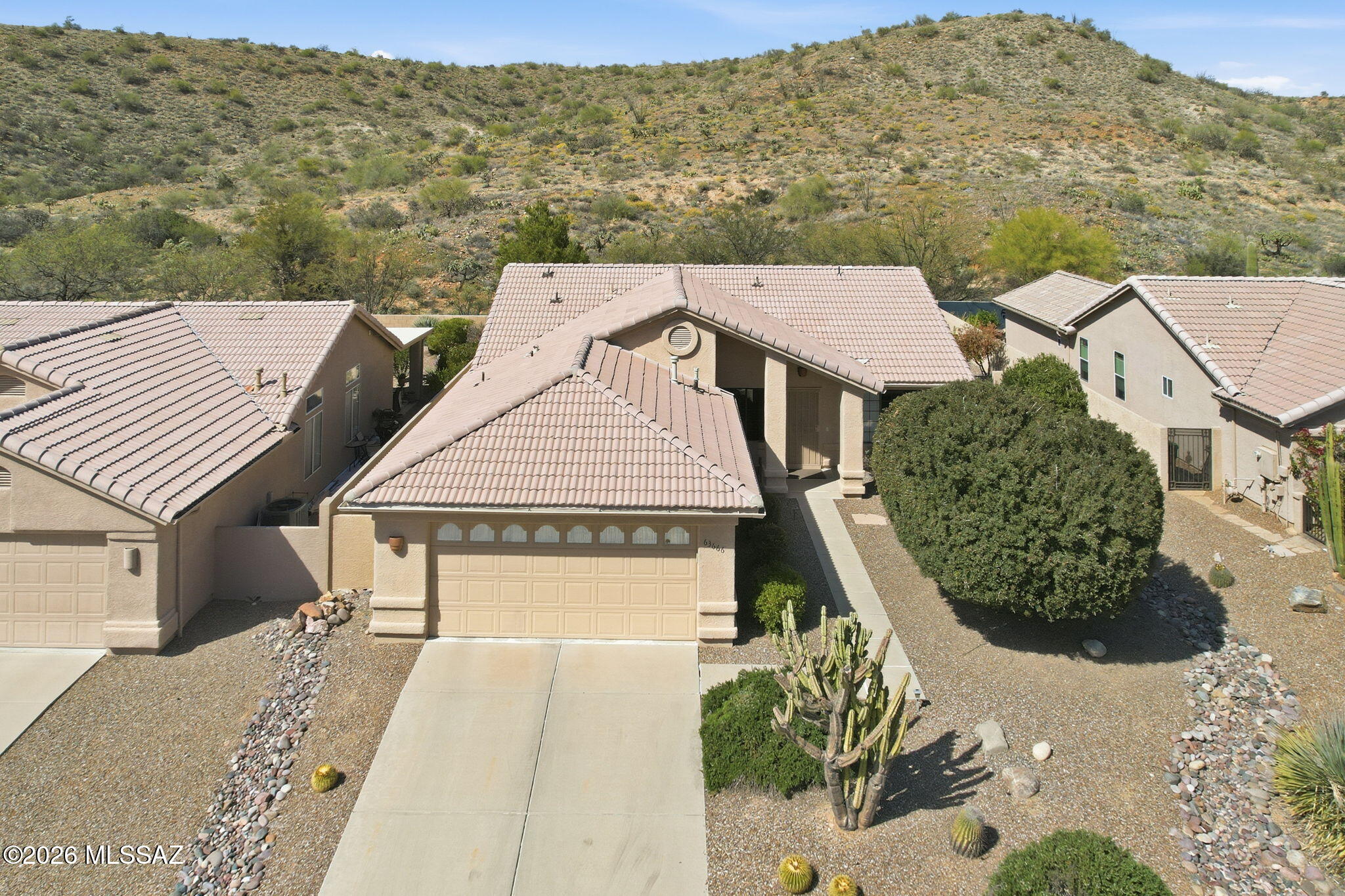 Fabulous 3BD/2BA (1,810 sq ft) Diego model boasts vaulted ceilings, plantation shutters, large diagonal set tile and screened Arizona Room for year round enjoyment. Charming home backs to hill for ultimate privacy. Enter to a formal Living room that flows to a Great Room. Chef's kitchen offers large island with bar seating, breakfast nook with bay window plus sleek black appliances. Striking Primary suite has large picture window overlooking the yard. En suite bath hosts dual sink vanity and walk-in shower. Bedroom 2 has walk-in closet; bedroom 3 could double as an office. Laundry room has built-in desk. Extended 2 car garage houses storage cabinets, utility sink, newer HVAC (2025) and water heater (2021). SaddleBrooke Active Adult Community residents enjoy access to a clubhouse, fitness center, restaurants, championship golf, tennis, swimming, social calendar and more!