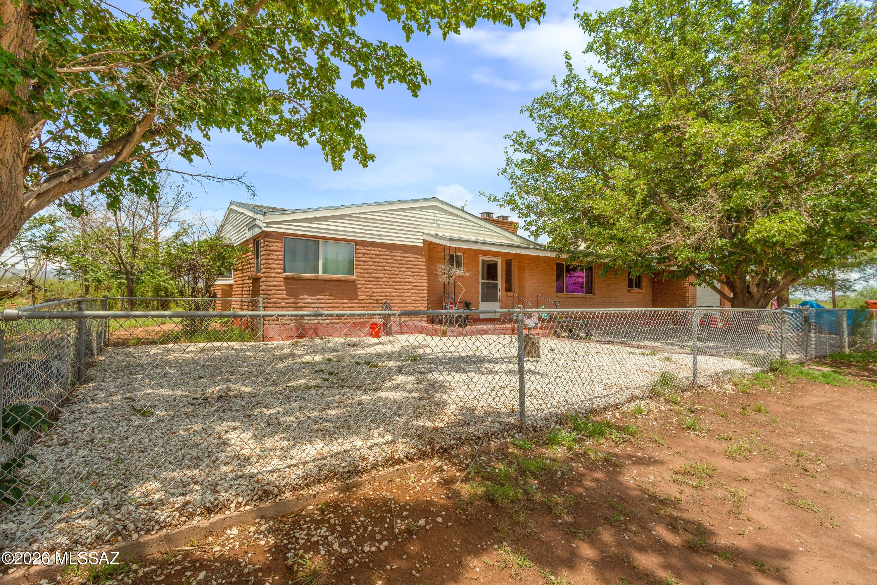 Cozy 3bdm, 2 1/2 bath home with 2 fireplaces on 10 acres. Updates in the past 2 years include roofs for the house and large shed, granite kitchen counter tops, new oven & microwave, new AC unit, updated wiring, paint & window coverings, and laminate floor in the formal LR, 1 BR & dining room. True country setting with a private well & newer septic. Indoor storage off laundry room which has a half-bath and access to the back yard which includes a brick well house large enough to provide work space or storage. Fenced back and front yards for children or pets with perimeter wire fencing. Large hall bath has double vanity and tub. Lovely garden/bay window in the middle room. Covered patio off the Family room is great for watching sunsets. Primary bedroom has private access to the back yard