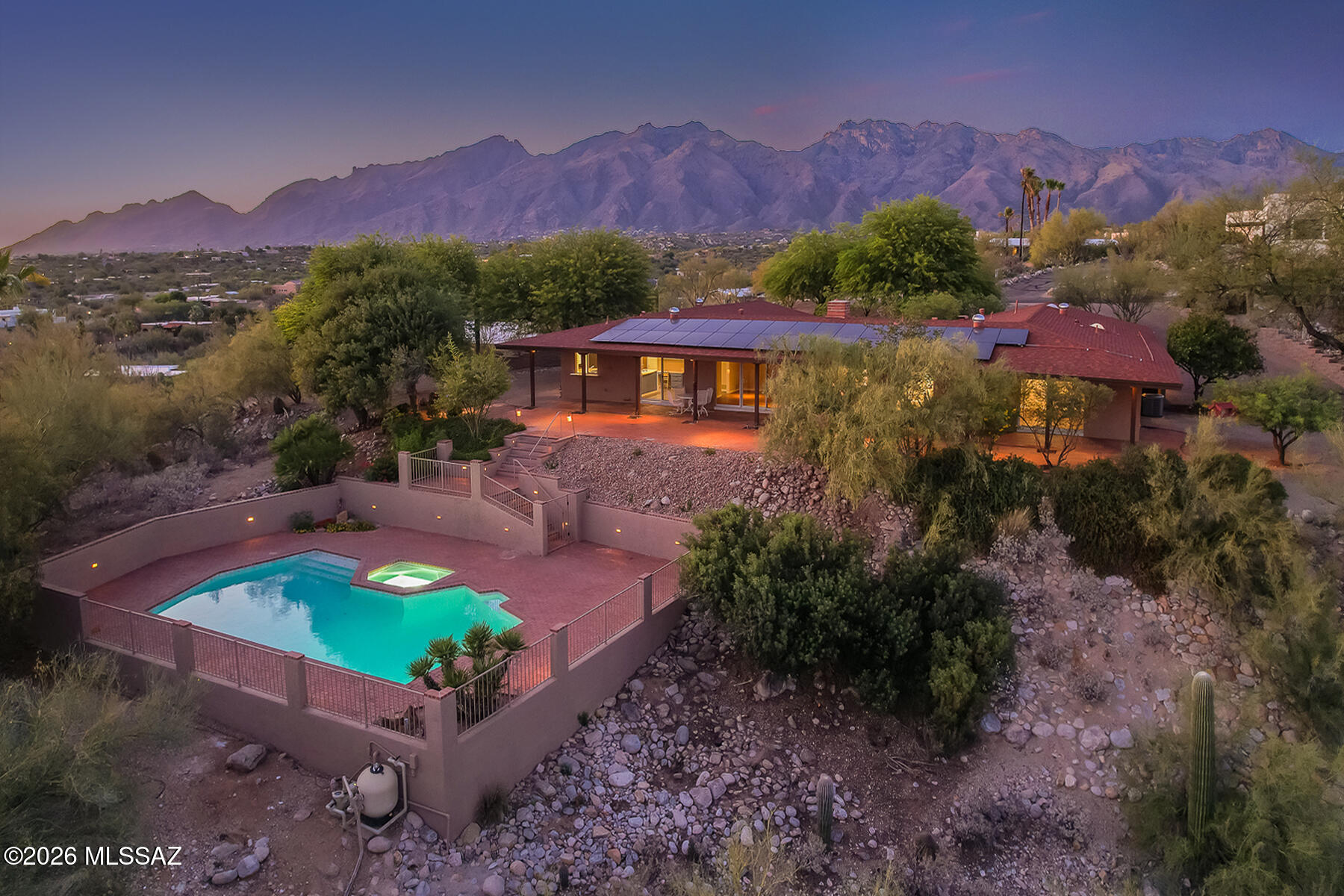 Stunning panoramic city & mountain views frame this wonderful updated custom home. Nestled on a .8-acre elevated lot in the heart of the foothills. Charming courtyard leads to a spacious 3BR/3BA floorplan. Family rm w/high wood beamed cathedral ceilings & fireplace. Updated kitchen w/beautiful custom cabinetry & SS appliances.  Spacious living & formal dining rooms. Custom built-in cabinetry & plantation shutters.  Wonderful views from almost every room. Painted inside & out, newer roof, updated electrical, solar system, brick driveways.  Outdoor living at its finest with the large, renovated pool, soaking tub & large, covered patio w/stunning views! See More Section about adjacent .8-acre lot for sale & estate sale. See attached documents for $90,000 in recent in improvements & floorplan. Rare opportunity! Buyers of the home have the option to purchase the adjacent .8 acre +/- lot (109-27-0640 AKA lot 64) to consider a family compound...a multigenerational 3000 sq foot home, casita and/or home office. The lot offers unobstructed beautiful city and mountain views. See survey map in attached documents which shows the vacant lot. Call Listing Agent for more info. 

Estate sale. Seller has never lived in the home. Please write in offer that there are no SPDS available. Please use Agave Title, Kelly Ladrido Escrow Officer. 520-918-1683. Kellyl@agavetitle.com. Title Commitment in attached documents. Please include at least 2% in earnest money with any offer. 

See attached documents section for approx. $90,000 in recent improvements, survey, roof warranty, solar contract, floor plan, etc.

Note large pool and soaking spa/tub (no jets) was recently renovated with new plaster/tile, etc. The pool is approx. 33' long and the pool depth run from 3' to 9'. Extensive renovations took place in April 2026.

The family room, kitchen and primary bedroom have oversized sliding glass doors that open to a 54ft covered patio to view the sunrise to the beautiful city lights. 

Very convenient foothill's location! Only a 5 min drive to Whole Foods, Basis North, St. Gregory School, TMC and The Loop (miles of vehicle free) for biking and walking. Only a 10 min. drive to hike in Sabino Canyon and the Canyon Ranch Resort.