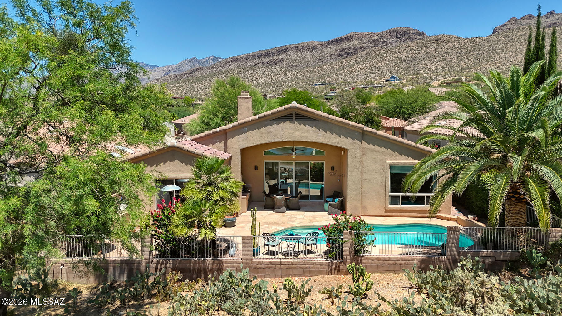 Enjoy resort-style living in this 2,300 sq. ft. contemporary home located on a premium lot in a 24-hour guard-gated community at Arizona National Golf Course. Offering 3 bedrooms, 2.5 baths, this bright open floor plan features soaring ceilings, a spacious living room with fireplace, large windows, and stunning views. The family room, Living Room and primary suite both open to the east-facing patio overlooking a sparkling pool, buffer area & golf course. The kitchen includes granite countertops, cherry-stained alder cabinets, breakfast bar, and island. Additional highlights include a 3-car garage with abundant storage, ceramic tile flooring, laundry room, new HVAC (2025). Close to hiking trails, parks, schools, recreation center, and community pool.