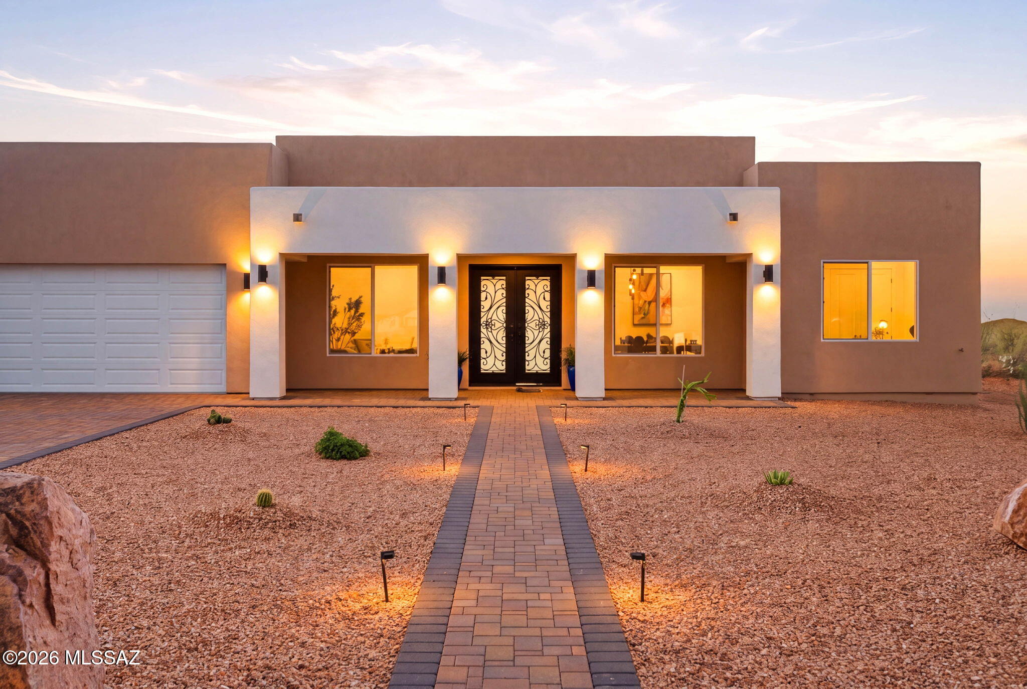 Never before lived in, 2026 custom built home sitting on .91 of an acre. With mountain views and an oversized 3 car garage, RV hook ups and plenty of space for all your toys. Modern interior finishes make for a sleek high-end design. The chef's kitchen features quartzite countertops, 6 burner range with pot filler and energy efficient appliances with an oversized island. Two living rooms, a formal dining room and an eat in kitchen there is plenty of space to entertain the whole family. The resort style primary bedroom offers a dual vanity, soaking tub with a separate shower and dual shower heads and a walk-in closet. You'll never need to book a spa day again with this ensuite. The luxury finishes continue to the guest quarters; both guest bathrooms feature walk in showers with rain shower heads. The backyard has views of the Rincon Mountain range and landscaped with decorative gravel, fruit trees, pavers and turf as well as an oversized covered porch. This home is custom build, move in ready and priced better than any other custom home in the neighborhood. Don't miss the opportunity to make this house your home.