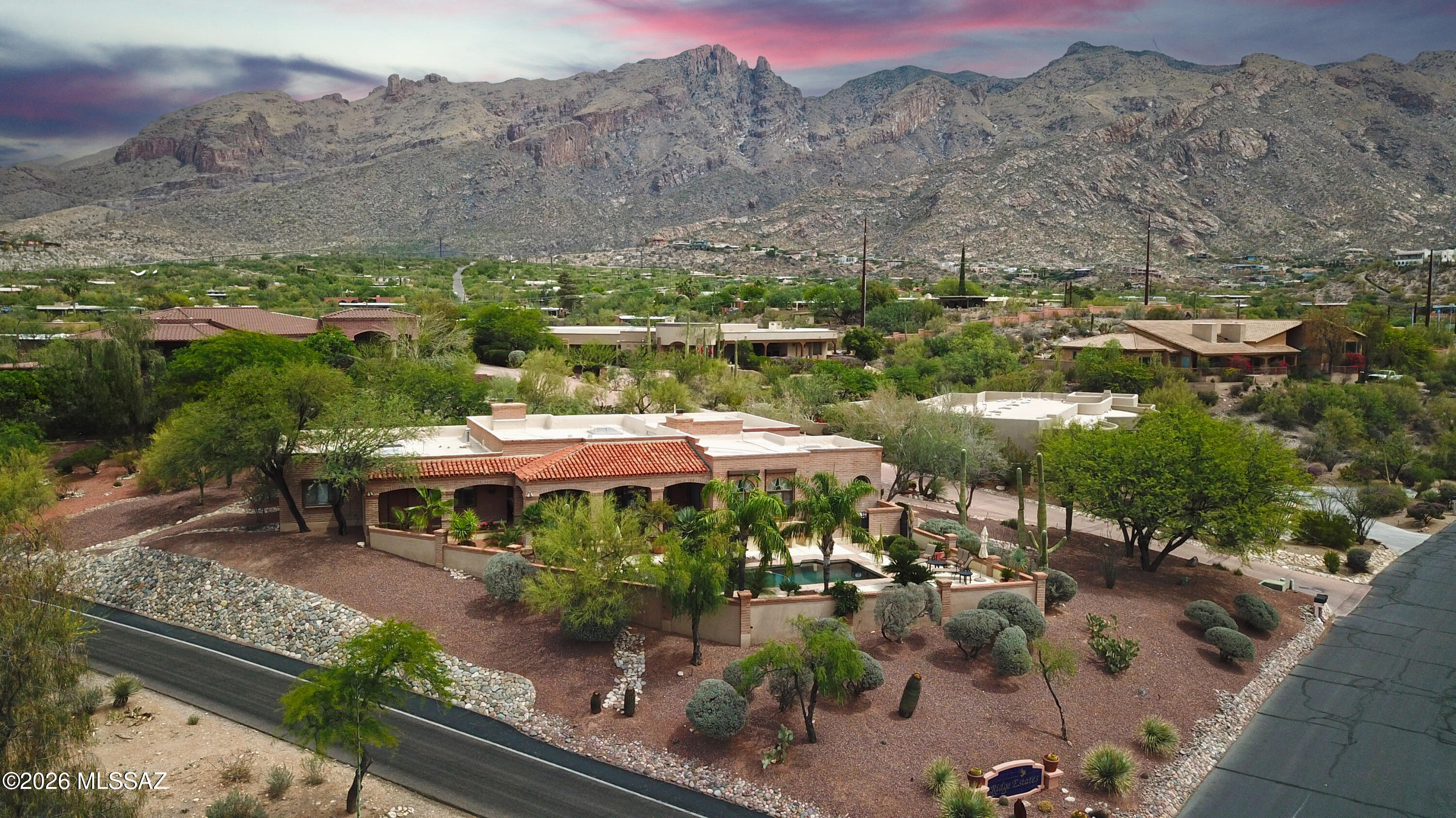 Located behind the prestigious guard-gated entrance of La Paloma in Tucson's highly sought-after Catalina Foothills, 4001 E Camino Montecillo is an exceptional luxury residence that perfectly captures the elegance, privacy, and resort-style lifestyle synonymous with one of Southern Arizona's premier communities. Constructed with timeless burnt adobe masonry, the home blends authentic Southwestern character with sophisticated design and enduring quality, offering both architectural distinction and energy-efficient comfort. Spanning approximately 4,468 square feet, this beautifully designed residence features 4 spacious bedrooms and 5 bathrooms, thoughtfully laid out to provide both grand entertaining spaces and comfortable everyday living. Expansive windows and glass doors fill the home with natural light while showcasing breathtaking city light, mountain, and desert views that create a dramatic backdrop throughout the property. Rich architectural details, soaring ceilings, and warm desert finishes combine to create an inviting yet refined atmosphere.

The gourmet kitchen is designed for the culinary enthusiast and entertainer alike, featuring premium Viking appliances, generous prep space, custom cabinetry, and seamless flow into the home's living and dining areas. Multiple indoor and outdoor gathering spaces allow for effortless entertaining while embracing Tucson's year-round indoor-outdoor lifestyle.

The exterior setting is equally impressive, surrounded by mature desert landscaping that enhances both privacy and beauty while complementing the natural Sonoran Desert environment. The resort-style pool area provides the perfect setting to relax, entertain, or enjoy Tucson's spectacular sunsets and sparkling city views. A spacious 3-car garage offers ample room for vehicles, storage, and recreational equipment.

Positioned within the acclaimed Catalina Foothills School District, the property offers access to some of Tucson's most highly regarded schools while being moments from upscale shopping, fine dining, luxury resorts, hiking trails, and premier golf destinations including La Paloma Country Club. The location delivers the ideal balance of convenience, prestige, and tranquility.

4001 E Camino Montecillo represents a rare opportunity to experience luxury Foothills living in one of Tucson's most desirable guard-gated communities, where timeless burnt adobe architecture, spectacular views, mature landscaping, and exceptional amenities come together to create an extraordinary desert retreat.