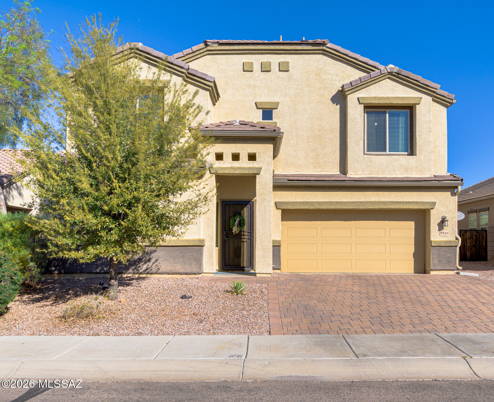 This isn't your typical builder-grade home! Almost every inch has been thoughtfully upgraded with custom design touches throughout, making it truly one-of-a-kind. From the moment you walk inside, you'll notice the difference. The main floor offers a versatile den, full bathroom, and an abundance of storage. The great room features soaring ceilings, built-in bookshelves, and an open floor plan that seamlessly connects the main living space to the kitchen and dining room. The kitchen is the heart of the home and is truly designed to impress. You will love the stunning backsplash, stainless steel appliances, kitchen island, and walk-in pantry. The primary bedroom offers a comfortable and private retreat with ample space and natural light. Step outside to a meticulously designed backyard where pavers and artificial turf create a low-maintenance and beautiful setting for relaxing or hosting friends and family. The outdoor space feels private and polished, perfectly complementing the home's elevated interior finishes. Living in Saguaro Bloom means enjoying an incredible lineup of community amenities including resort-style pools, parks, a basketball court, and miles of walking and biking trails. It's easy to see why so many people are choosing to call this community home.