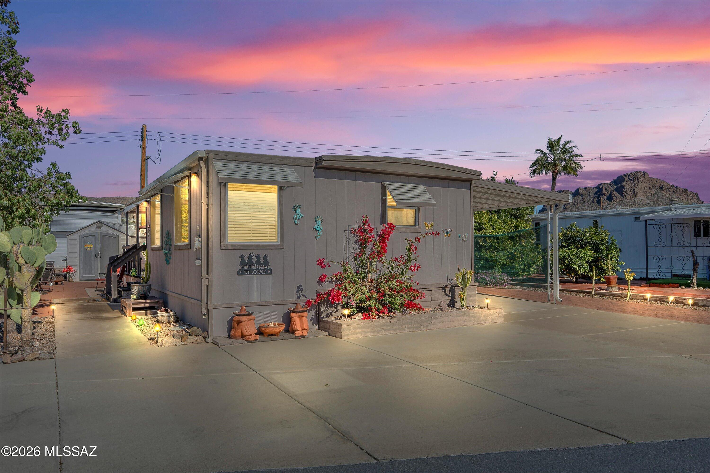 Welcome to a charming desert escape! This well-cared-for 1968 mobile home offers 832 sq ft with 2 bedrooms and 1 bath and has been lightly used by the last two owners as a seasonal retreat. Everything is functional and ready to enjoy, featuring dual-pane windows, insulation, oak cabinets, and a convenient laundry chute from the bathroom to the laundry room. Outside, enjoy prickly pear cactus, unique bottle tree, and peaceful sunsets from your porch swing with morning coffee or evening tea. Sold fully furnished it's move-in ready—perfect if you're retiring to Tucson or extending your seasonal stays. Located in an active 55+ community w/ hundreds of clubs, an 18-hole golf course, rec center, pools, spa, sauna, tennis, pickleball, shuffleboard, fitness room, and more—all included in low H