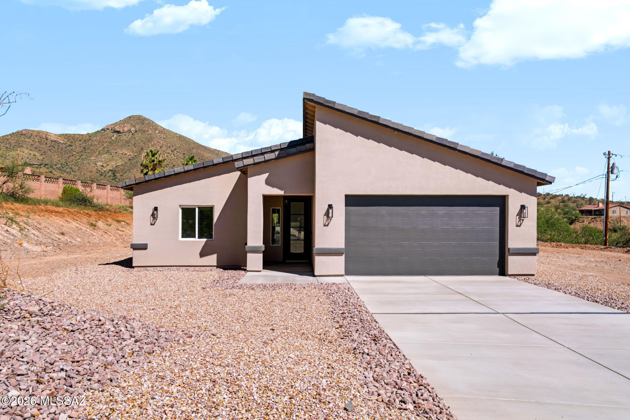 Perched on a scenic hillside, this 4-bedroom, 2-bathroom home offers 1,735 sq ft of modern living with breathtaking mountain and city views. The elevated lot provides privacy while showcasing sweeping vistas from multiple areas of the home. Inside, clean lines and contemporary finishes define the space, including quartz countertops and large-format 24x48 ceramic tile flooring. The open layout seamlessly connects the kitchen and living areas, ideal for everyday living and entertaining. Striking modern pitched rooflines with varied angles give the home a unique, elevated curb appeal. With its blend of style, function, and unbeatable views, this hillside property offers a rare opportunity for refined living. 
OWNER/AGENT

Address can also appear as 415 Camino Osito per building permit.