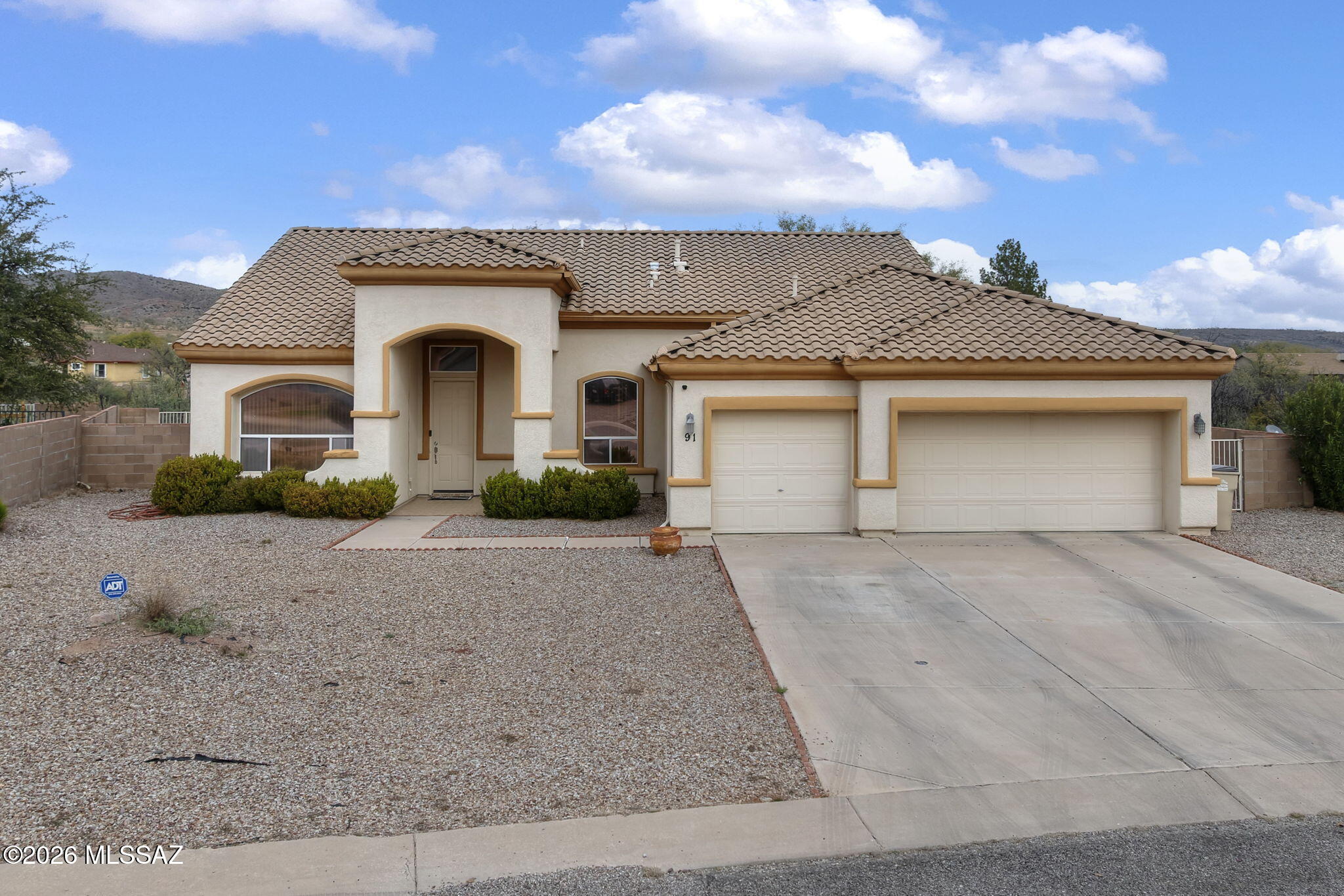 Located in the heart of Rio Rico with easy access to the freeway, shopping, and dining, this well-designed home offers comfort and functionality throughout. The spacious primary suite features a soaking tub and separate shower, complemented by three additional bedrooms and a full guest bathroom. Enjoy formal living and dining areas, plus a kitchen with breakfast bar and nook that opens to the family room with a cozy fireplace—perfect for everyday living and entertaining. The backyard includes a covered patio and block wall for added privacy. Complete with a three-car garage. A must-see—show and sell!