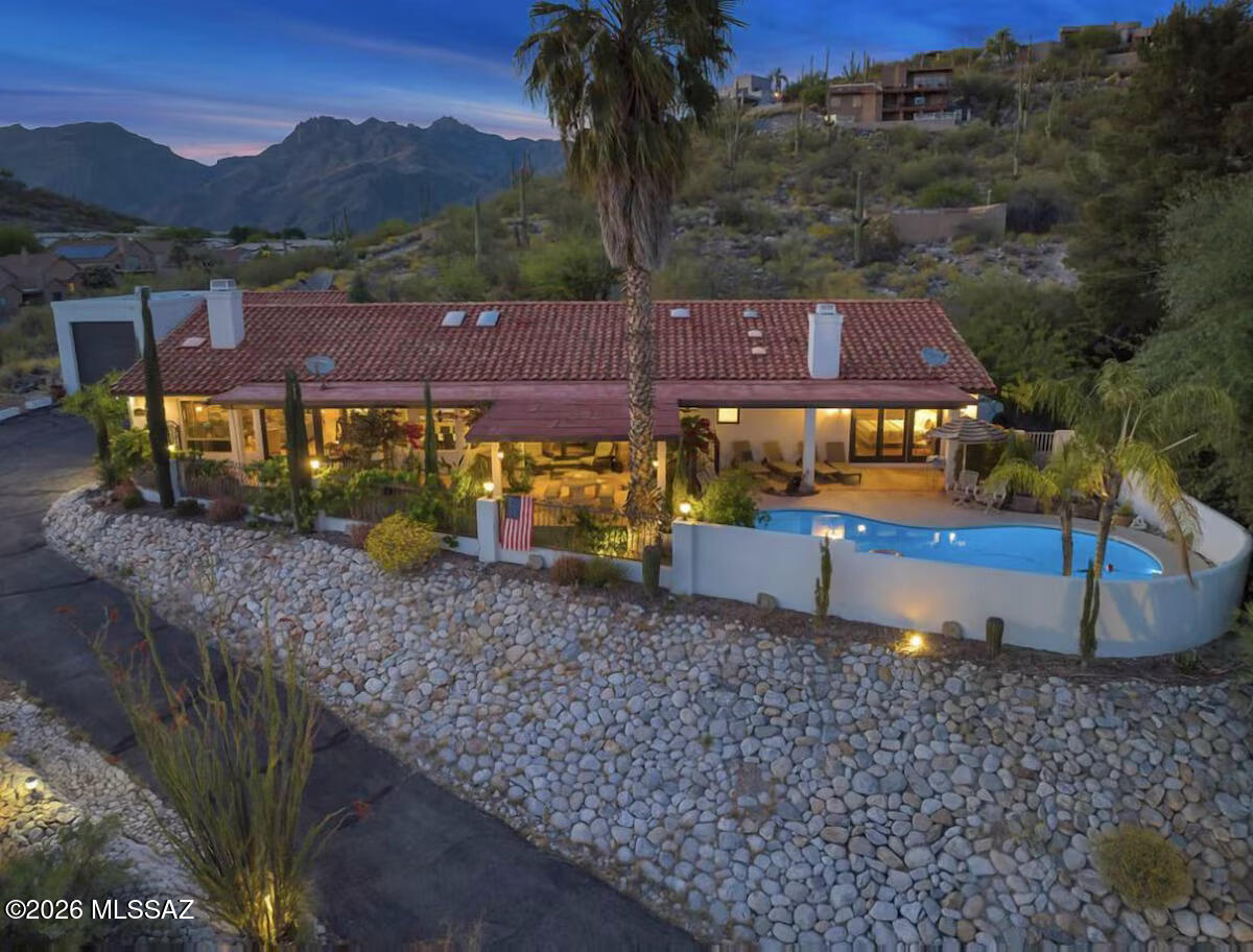 Experience the charm of this remarkable Spanish-style hillside residence at Rockcliff! This elegant home boasts exceptional curb appeal, featuring an RV garage, a 2-car garage, and a spacious gated courtyard with a flagstone floor. Step through custom double entry doors to discover sophisticated design and meticulous attention to detail, with a floor plan thoughtfully centered around the gourmet kitchen. Enjoy a generous formal dining room, elegant wood flooring, tile in high-traffic areas, skylights, and vaulted ceilings. The expansive living room--with multi-sliding glass doors leading to the courtyard and a wet bar--shares a two-way fireplace with the inviting family area, creating a perfect setting to relax and admire breathtaking hill views. The gourmet kitchen offers abundant storage, granite countertops, a custom tile backsplash, a center island, and premium stainless steel appliances. The owner's suite provides outdoor access, a cozy fireplace, and an ensuite bathroom complete with two vanities, a jetted tub, and a spacious walk-in closet. Additional highlights include a large den that can serve as an office or extra bedroom, and a laundry room with a utility sink and generous storage. Step outside to a stunning backyard oasis, featuring an extended covered patio, artificial grass, a fenced pool, and unforgettable sunsets over the mountains. This spectacular home truly has it all!

Seller will accept or counter offers between $999,000.00 and $1,049,000.00
