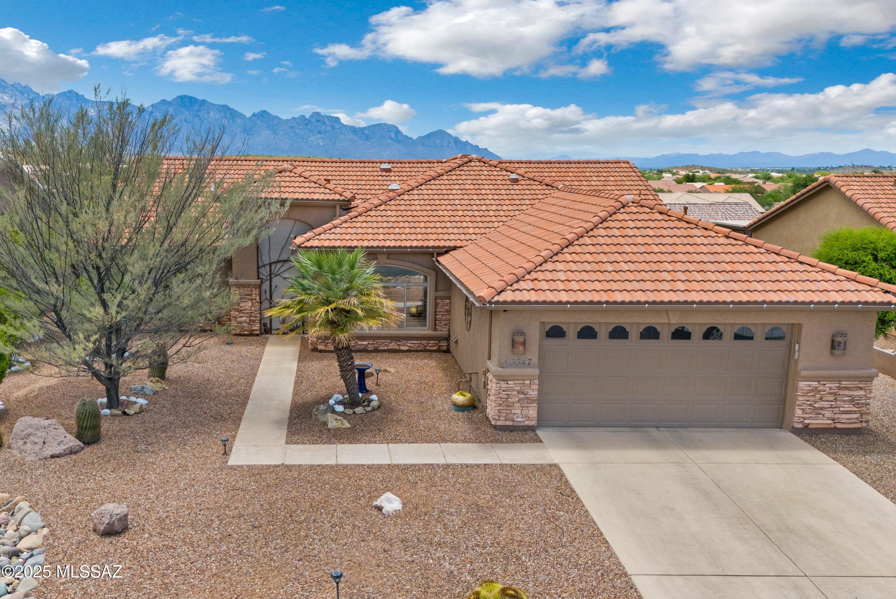 Updated Laredo with Mountain Views! Great Curb Appeal! Stacked Stone Front & 2 Screened Wrought Iron Doors. Great Room has Media Wall with Gas Fireplace & Slider to Patio. Kitchen with Granite Counters, Stainless Steel Appliances,  Induction Range, Custom Expanded Cabinets with Slide-outs & Kitchen Dining Area. Owner's Suite with Bay Window. Owner's Bathroom has Dual Vanity with Granite Counter, Walk-in Shower & Walk-in Closet. 2 Guest Bedrooms with Closets. Guest Bathroom with Walk-in Shower nearby. Laundry Room has W/D & Custom Cabinets. Luxury Vinyl & Tile Flooring. Plantation Shutters, 4 Solar Tubes & RV Outlet. Extended 2 Car Garage with 2023 HVAC & W/H, Utility Sink, Side Door, Pull Down Attic Stairs & Cabinets. Covered Patio, BBQ Station, Water Feature, Gated Yard & Mountain Views!