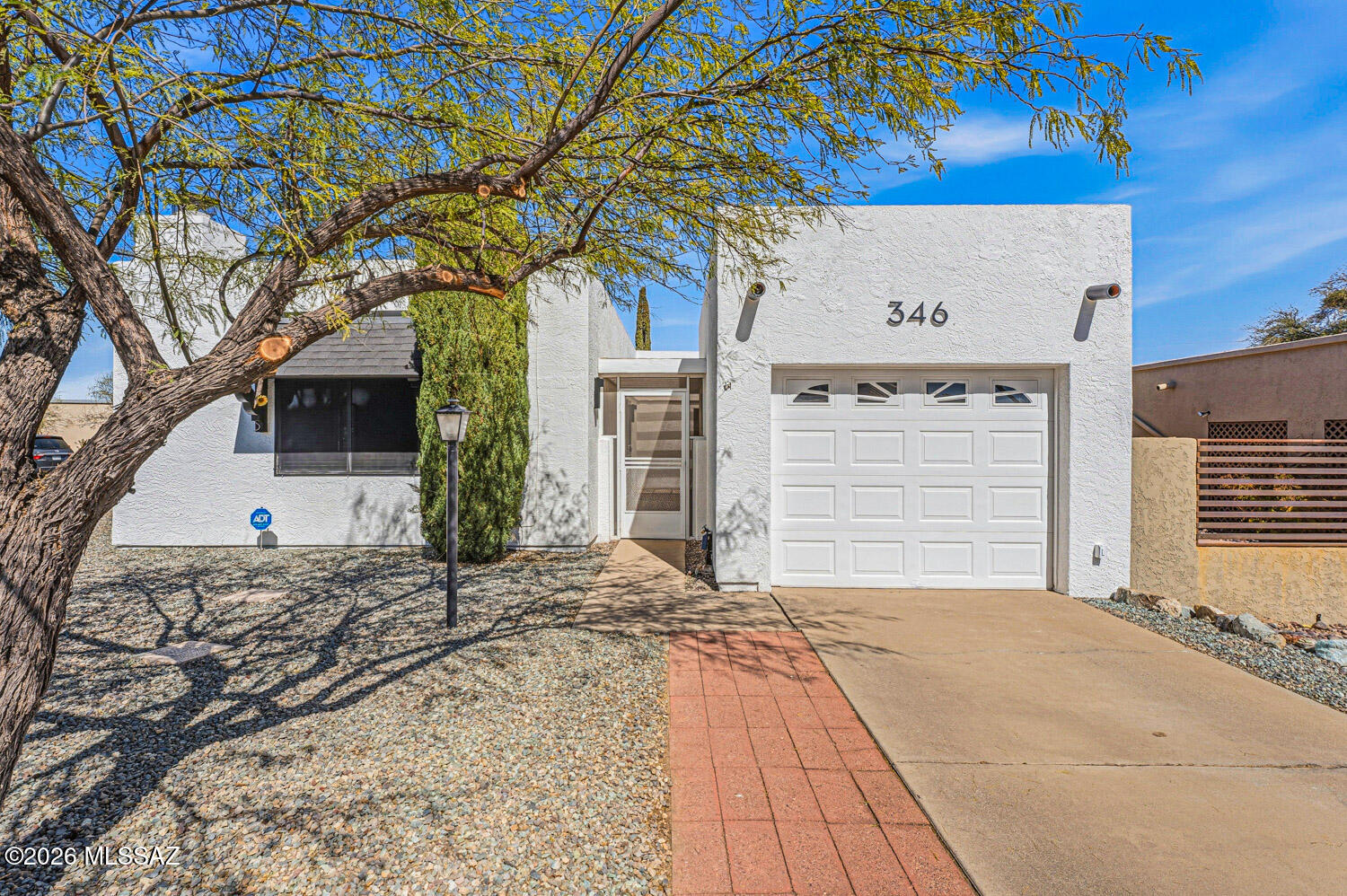 Find your perfect Arizona escape in this lovely 2-bedroom, 2-bath townhome with an Arizona room, ideally situated on a desirable corner lot! From the moment you step inside, you'll love the luxury vinyl plank flooring, cozy beehive fireplace, and updated lighting and ceiling fans that give the home a warm, modern vibe. The kitchen is both functional and fresh, featuring stainless steel appliances (2019), a stainless steel farmhouse sink with updated faucet, and newer laminate countertops. Peace of mind comes standard with a 5-year-old HVAC system, roof recoated in 2024 with high-quality materials, and a water heater replaced in 2020. Both bathrooms have been fully remodeled with sleek modern vanities, updated fixtures, new flooring and mirrors. The Arizona room offers incredible flexibility, perfect as a home office, hobby room, or creative studio. A screened-in porch extends your living space even more, giving you the perfect spot to relax and enjoy beautiful afternoons. The low-care backyard with pavers makes outdoor living easy and enjoyable. Additional features include: Laundry room with washer & dryer (2019) included, 1-car garage with ceiling storage rack, Insulated patio Arcadia door, Metal skylight hail guards, guest parking conveniently located right in front. Located close to Green Valley Recreation's pool, shopping, and everyday conveniences, this 55+ community home with GVR membership offers the lifestyle you've been waiting for.