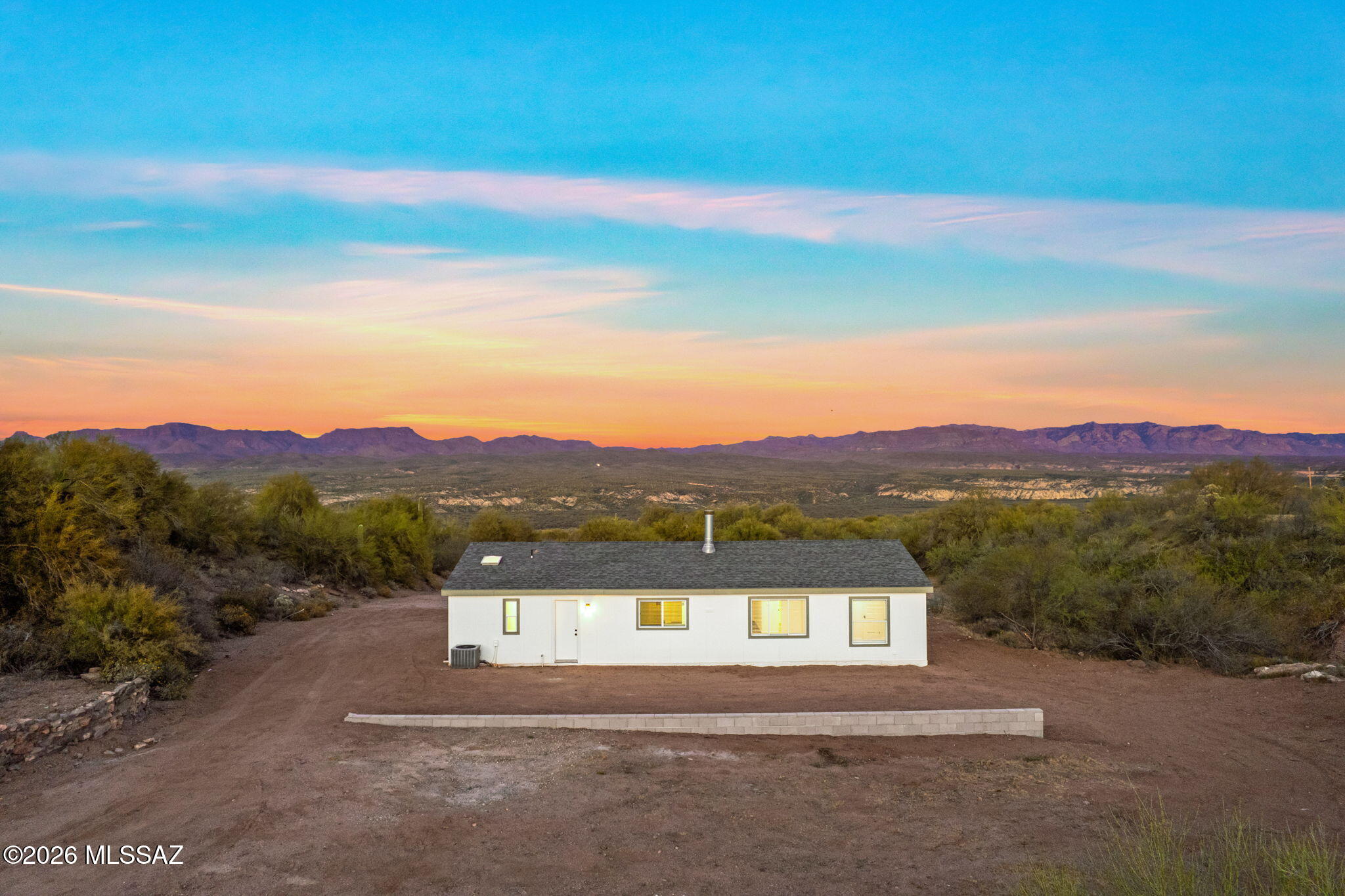 Views! Views! Views! Don't miss this rare opportunity to own 3.38 acres of affordable Arizona living in Mammoth. This fully updated 3-bedroom, 2-bath home offers privacy, space, and unforgettable star-filled skies. With a brand-new roof and an easy commute to Tucson, it's the perfect blend of peaceful country living and everyday convenience. Inside, you'll find granite countertops, new kitchen appliances, luxury vinyl plank flooring, and a cozy wood-burning fireplace, with additional upgrades throughout. Step outside to sweeping mountain views, stunning sunrises/sunsets, and endless room to garden, explore, or expand. Opportunities like this don't come often, experience the space, serenity, and lifestyle this property offers. Zoned SR (suburban ranch) incase you want to bring farm friends!