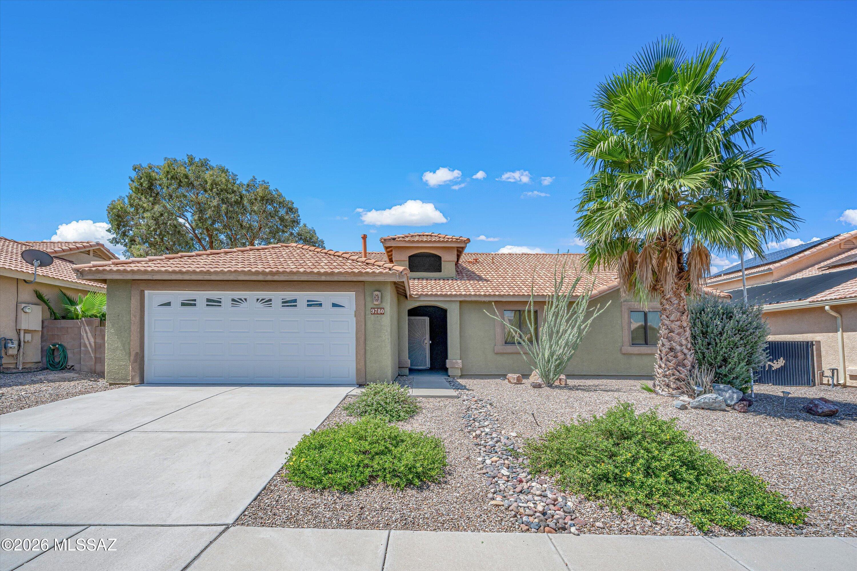 Welcome to this beautifully refreshed 4-bedroom, 2-bath home offering 2,156 sq ft and a sparkling gated pool! Inside, enjoy easy-care ceramic tile, new carpet and fresh paint. The spacious eat-in kitchen features a tile backsplash, pantry and breakfast bar with seating, additional dining space nearby and a slider opening to the patio and pool. The primary suite offers a walk-in closet and generous counter space. Outdoors, relax by the pool on the extended paver patio with shade screens, ceiling fans, mature fruit trees and low-maintenance artificial turf. Located in The Award-Winning Vail School District, near parks, shopping, dining and I-10.