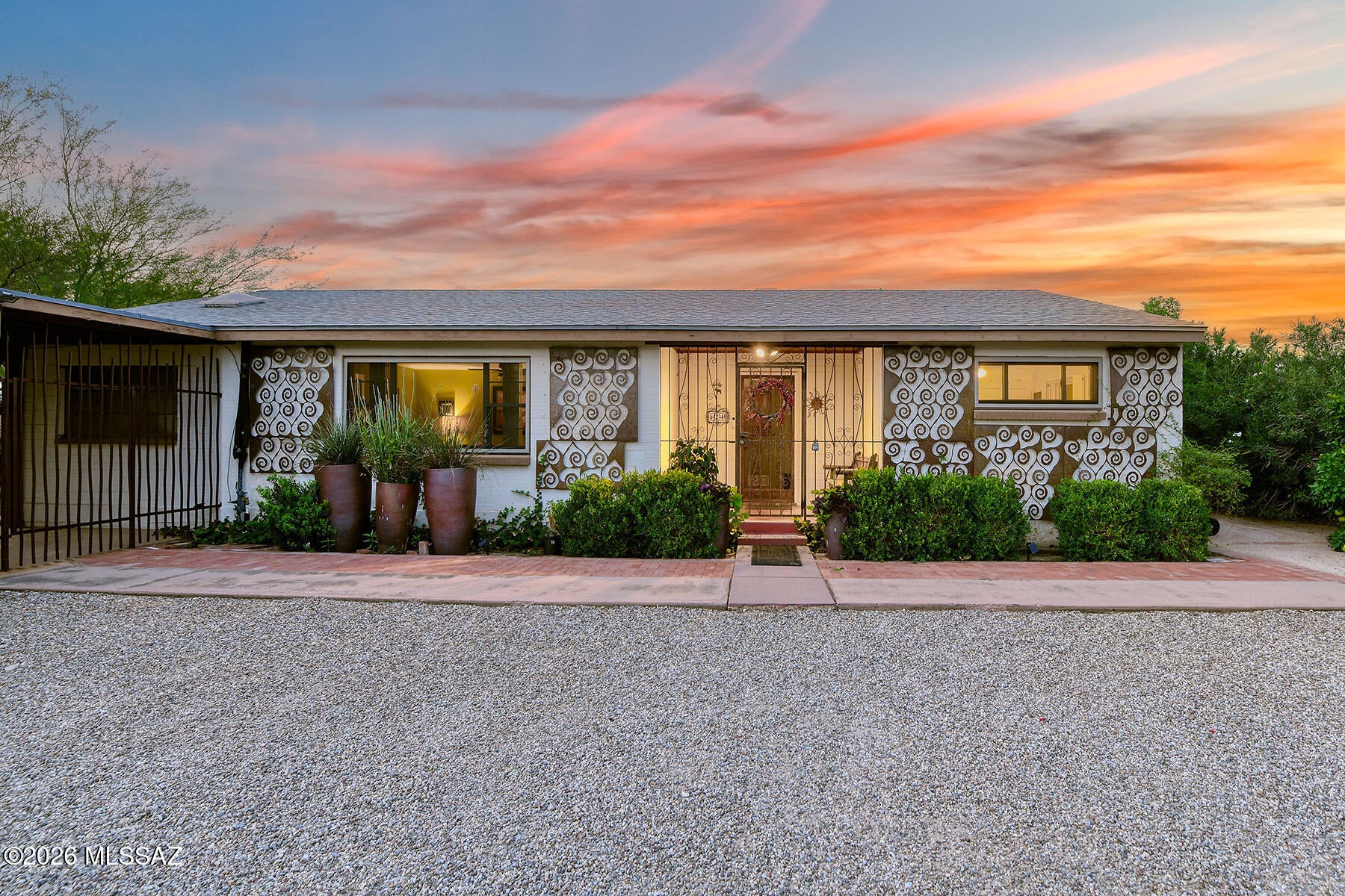 Alvernon Addition, distinctive and exceptionally well cared for, this 2,437-square-foot, four-bedroom, two-bath home is ideally located in Central Tucson on an expansive 11,339-square-foot lot. The spacious interior offers both a large living room and a separate family room, with walls of windows overlooking the lush backyard, pool, and spa. The kitchen provides ample storage, stainless steel appliances, and an open connection to the family room, complete with a fireplace. Ceramic tile runs throughout most of the home, with wood-like flooring in 3 bedrooms. 
Numerous thoughtful upgrades include owned solar, energy-efficient Andersen windows throughout, security screens, an upgraded electrical panel and subpanel, and a sewer line that has been relined from the home to the street. home to the street. The backyard is a private and inviting retreat, surrounded by beautiful mature landscaping and fruit trees. A covered ramada, rain garden, hot tub, and Pebble Tec pool create an ideal setting for relaxing and entertaining. A separate 239-square-foot heated storage room offers exceptional additional space for a workshop, hobbies, or storage. The enclosed wrought-iron carport provides secure covered parking and completes this well-maintained Central Tucson property.
