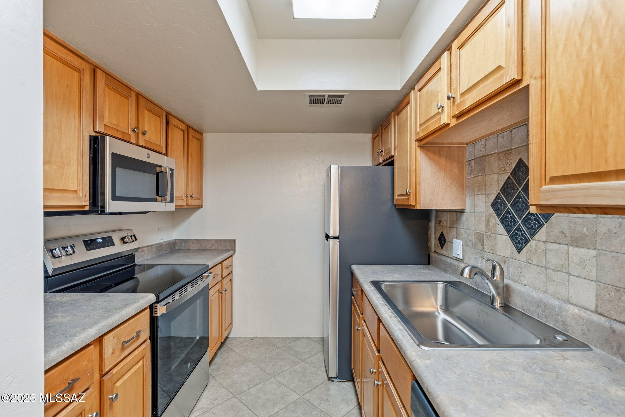 Welcome home to this beautifully updated condo located in a gated community with fantastic amenities! Inside, you'll find new luxury vinyl plank flooring and ceramic tile throughout--no carpet! The kitchen features a stylish travertine backsplash along with new stainless steel appliances, including a refrigerator, dishwasher, and microwave.

The remodeled bathroom offers a fresh, modern feel with a new vanity, beautifully tiled tub/shower surround, and a new toilet. Additional updates include new electrical outlets, ceiling fans, and a convenient storage shed with a secure lock. Enjoy the convenience of your assigned parking space (#834) located directly in front of the unit. Residents have access to a community pool, spa, and on-site laundry facilities, making this home perfect for low-maintenance living or as an investment opportunity.

Conveniently located near the University of Arizona, shopping, dining, parks, and other everyday amenities, this move-in-ready condo offers the perfect blend of comfort, style, and convenience. Don't miss this exceptional opportunity!