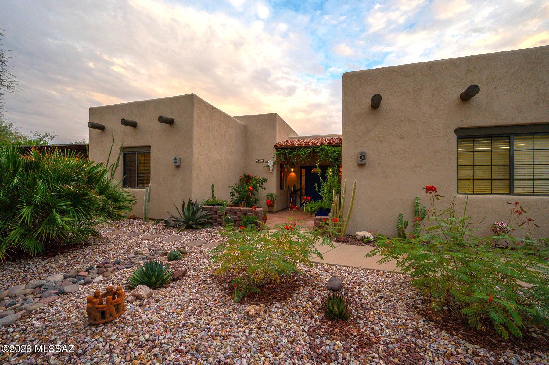 Gorgeous Southwestern-style home in the original Rocking K Ranch Estates, situated on 1.18 acres in the award-winning Vail School District. NO HOA! Check out the extensive features list for additional details. This single-level, split-bedroom plan features 3 bedrooms, 2 full baths, exposed beams, high ceilings, and warm Saltillo-style tile. The kitchen offers Indian marble countertops, breakfast bar, and dining area. Enjoy multiple outdoor living spaces, including a 560 sq ft solar-heated pool, covered patio,  freestanding ramada with ceiling fan and lights, and private contemplative/walking path. The attached 2-car garage includes storage and a utility sink. Space for RV parking on the property. Carrier 15-SEER HVAC and water heater new in 2021.