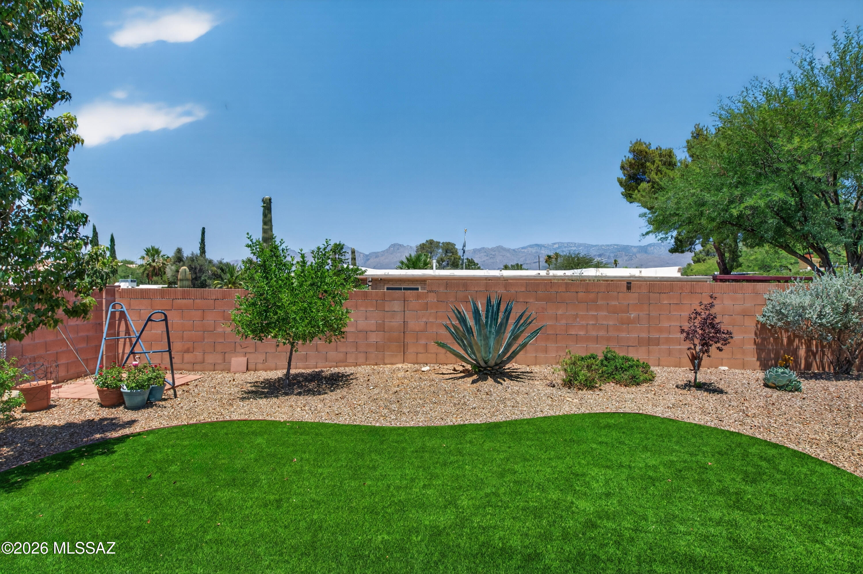 Updated corner-lot 3 bed/2 bath home in a cul-de-sac with long driveway, 2-car carport, den, and fireplace. Features upgraded tile flooring throughout with carpeted bedrooms, granite slab counters, single-basin stainless sink, RO water, glass rinser, and upgraded primary walk-in shower. Interior-access laundry room adds convenience. Enjoy mountain views from the kitchen/dining area and backyard. Outdoor space includes turf, pavers, and decorative rock. This is a strong buy with upgrades, views, location, transferable 2-year roof warranty, original FHA loan at ~3.75% may be assumable. Agent related to seller.
