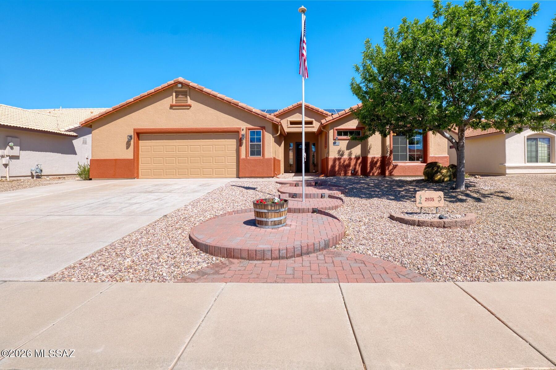 Mountain views from this beautiful R.L. Workman home in popular Canyon de Flores--NO HOA! This 3BR/2BA split-plan home offers 1,819 sq ft with vaulted ceilings, tile and carpet, and a new central AC/heat pump (2024). The open kitchen features rich wood cabinetry, stainless appliances, electric range, pantry, breakfast bar, island with sink, and water softener. Spacious bedrooms and full guest bath. The primary suite includes dual vanities, a custom walk-in shower with dual heads and seating, water closet, and walk-in closet. Enjoy mature front and back landscaping with circular paver entry, flagpole, covered patio, outdoor kitchen, water feature, grass yard, block wall, 3 sheds, and climate-controlled 2-car garage. Solar adds energy efficiency. Conveniently near everything!