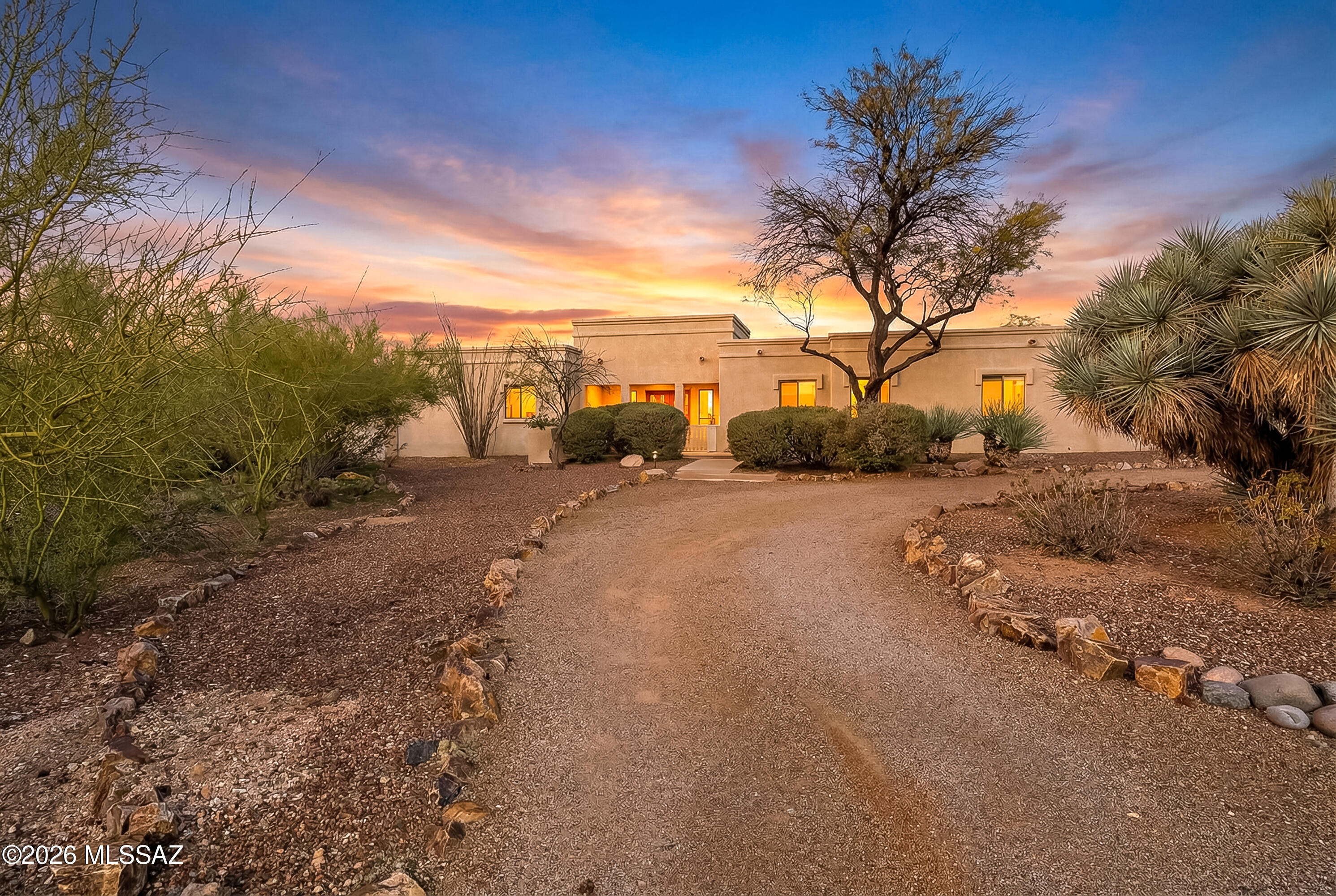 Shadow Hills: Picturesque Winding Streets, Stately Acre Estates. Perfectly situated in the Catalina Foothills, so close to the city! This residence is defined by open & spacious living! Circle Drive, Courtyard- an unforgettable arrival! The foyer leads to a welcoming Living Rm w/Fireplace & Beamed Ceiling. Dining & Kitchen w/tray ceilings! The kitchen offers 6ft+ from counter to the cooking/seating island open to bay breakfast nook & family rm opens to a deep cov. patio. No neighbors behind! Pool is sep. fenced. Kiva fireplace w/ Banco seating offers a magical spot to enjoy mountain views at sunset. 5BRs, thoughtful split plan w/Mobility enhanced 4th bath. Garage features 3 doors w/interior space for 4cars, plus a ducted project rm. Roof inv in docs, owned solar sys. &fresh interior paint.