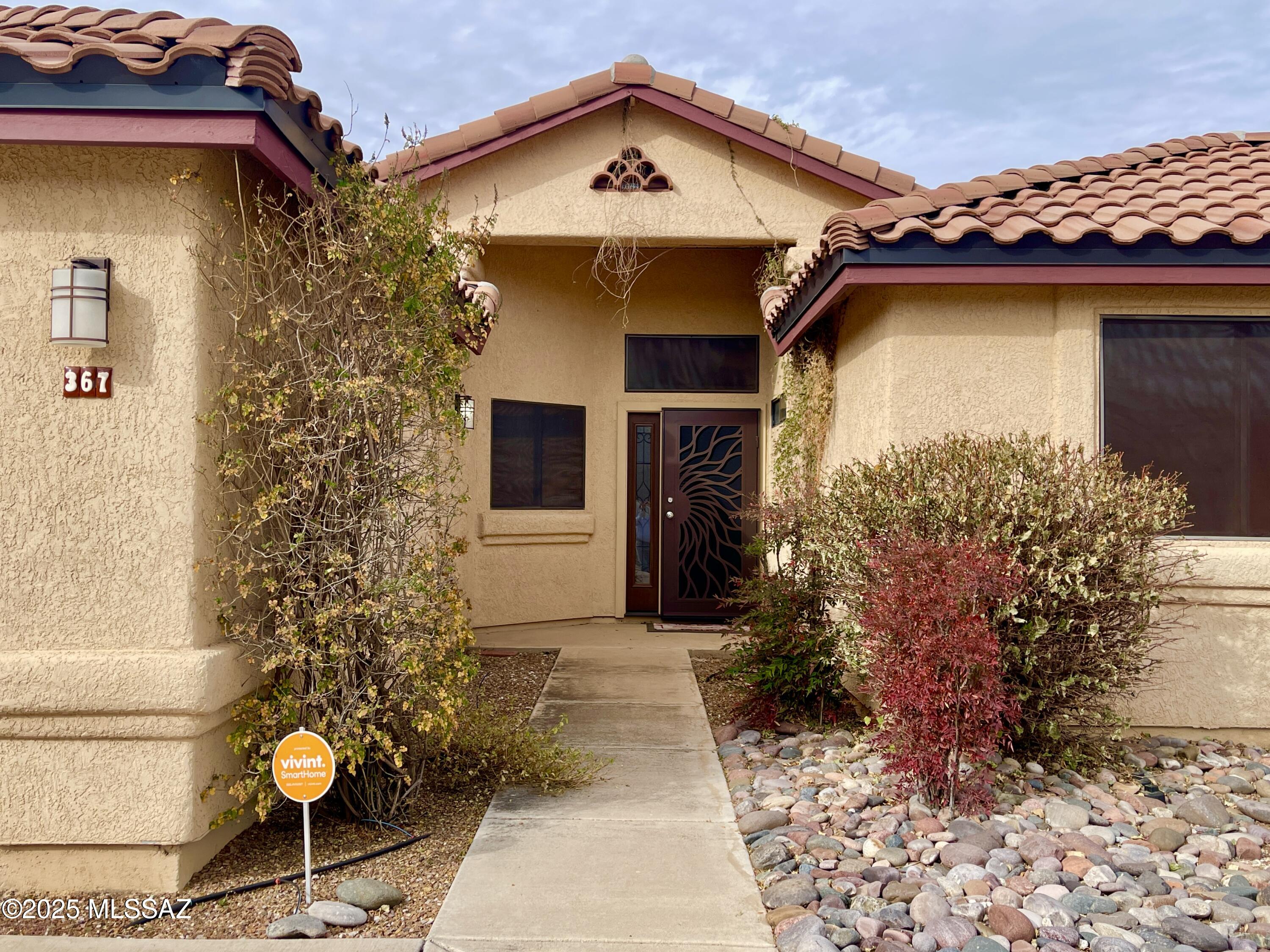 From the moment you arrive, you'll notice the desert-friendly landscaping & fresh exterior paint that create charming curb appeal. Inside, vaulted ceilings create a bright, open feel throughout the living spaces. A cozy gas fireplace anchors the living room, & nearby, a defined dining space adds a touch of elegance for hosting dinners or family gatherings. The kitchen has granite countertops, dark cabinetry, & stainless steel appliances including a gas range—ideal for home chefs. Down the hall, the spacious primary suite offers sliding glass doors to the backyard, and the en suite bath features a spa-like atmosphere with a soaking tub, walk-in shower, dual vanities, and modern tilework.Step outside to your own private oasis: a fully fenced backyard with a refreshing pool, complemented by mountain views and gorgeous sunsets. The covered patio provides shade for outdoor dining and relaxing. Roof replaced in 2017