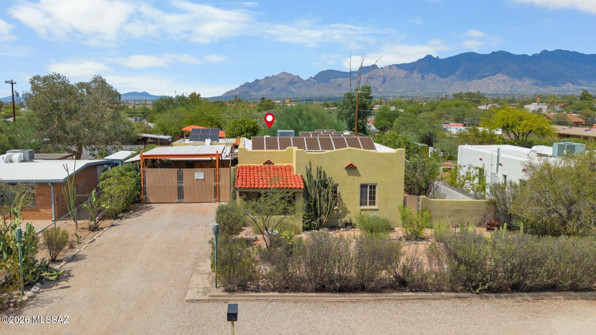 Built in 1935, this home has character with a 1329 square ft. 2 Br 1 Ba Main House with wood flooring and fresh interior painting throughout and a 613 square ft. Guest House with full kitchen attached workshop and a garage. Lush vegetation in both front and backyard.  Owned Solar for little to no electric bill and a rain water collection system. Dual pane windows for noise reduction and energy efficiency. EV charger installed. Close proximity to U of A and downtown.