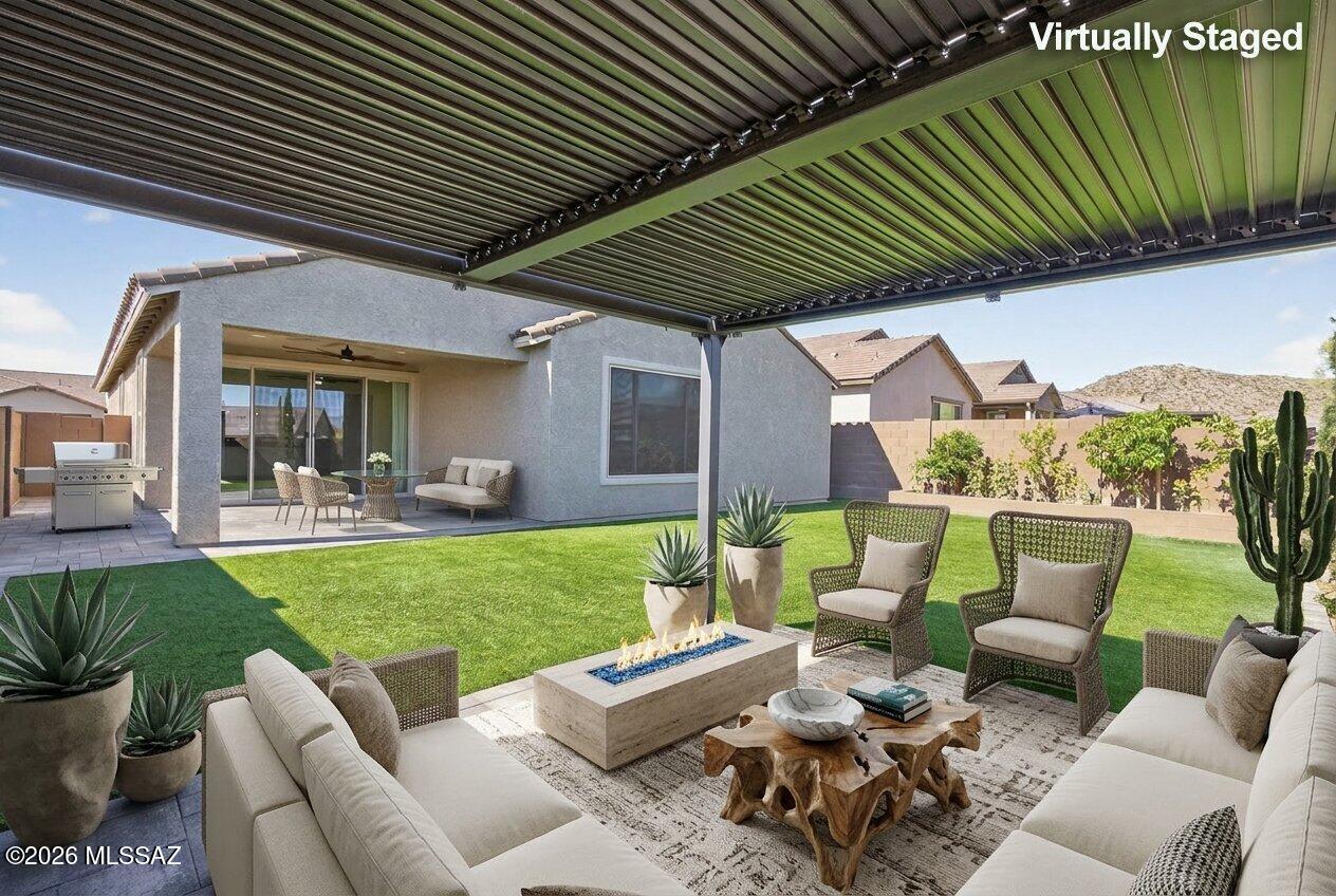 Over $100,000 in builder upgrades and owner enhancements already completed! This 2024 Dove Mountain home 8-foot doors, radiant barrier insulation, an extended garage and covered patio, and an open-concept layout. Owner improvements include a professionally landscaped backyard with pavers, synthetic turf, pergola and fruit trees, custom cabinetry and closet systems, laundry room with quartz countertops, whole-home water filtration, added insulation, epoxy garage floors, expanded driveway parking, privacy wall, and upgraded lighting throughout. Conveniently located luxury amenities of the The Ritz-Carlton, Dove Mountain, golf, hiking trails and more. Near shopping, dining, outdoor recreation, and everyday conveniences.