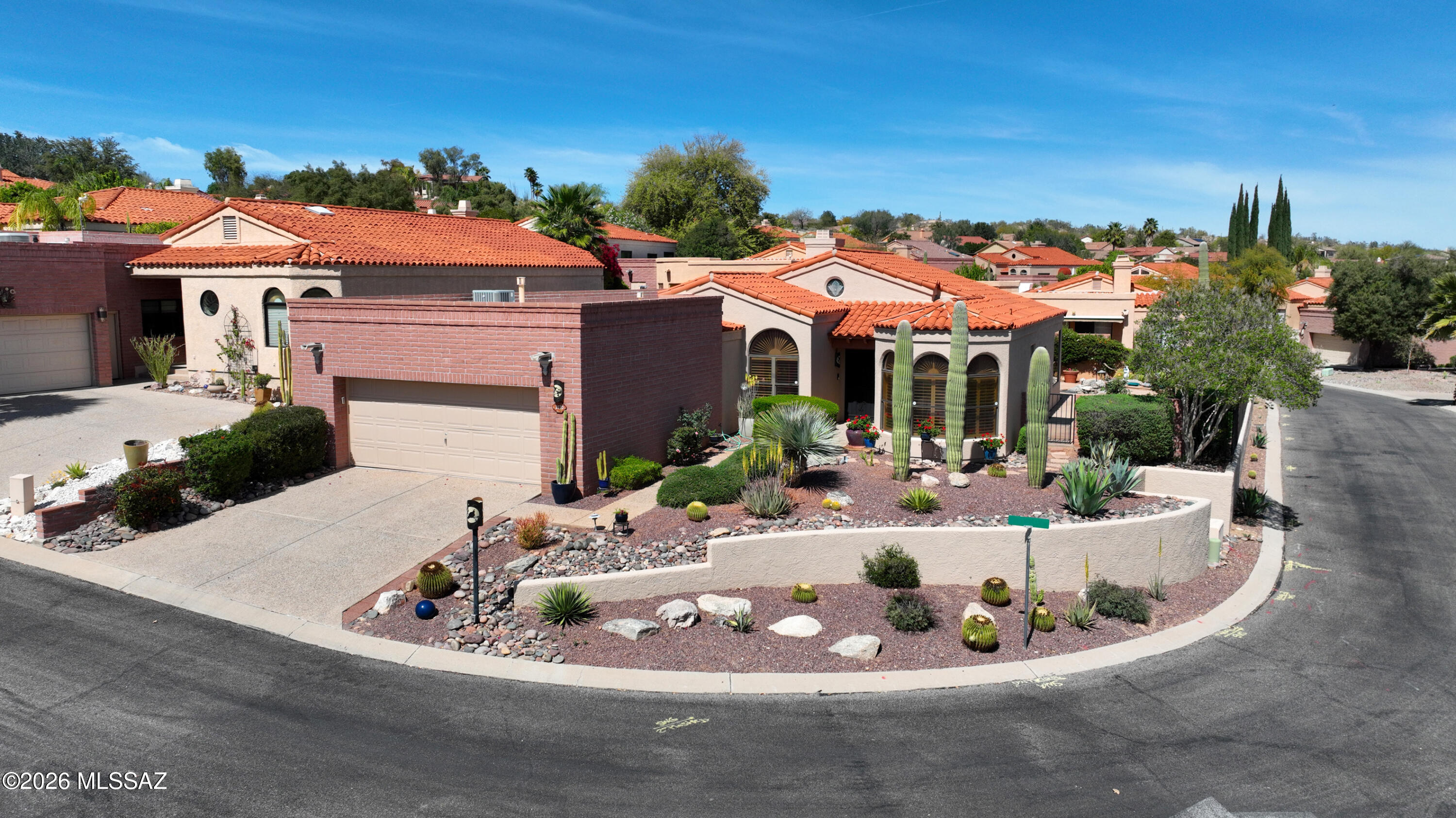 Majestic Catalina mountain views steal the show in this private, elevated corner lot retreat in desireable Fairway Heights @ Omni Tucson Nat'l.  2128 SF home captures stunning views from expansive picture windows in the open living/dining room areas. Inviting 3BR/2BA layout features a cozy fireplace and a bright kitchen with bay windows, breakfast nook, abundant cabinetry & mountain views.  Generous primary suite is a true retreat w/charming beehive fireplace, French doors to back patio & luxurious bath featuring soaking tub, sep shower, dual vanities & walk-in closets. Step outside to a private backyard oasis showcasing the Catalina views, tranquil waterfall/pond & covered patio. Guest bedroom includes walk-in closet & desk while 3rd bedroom is currently used as a tv/family room.