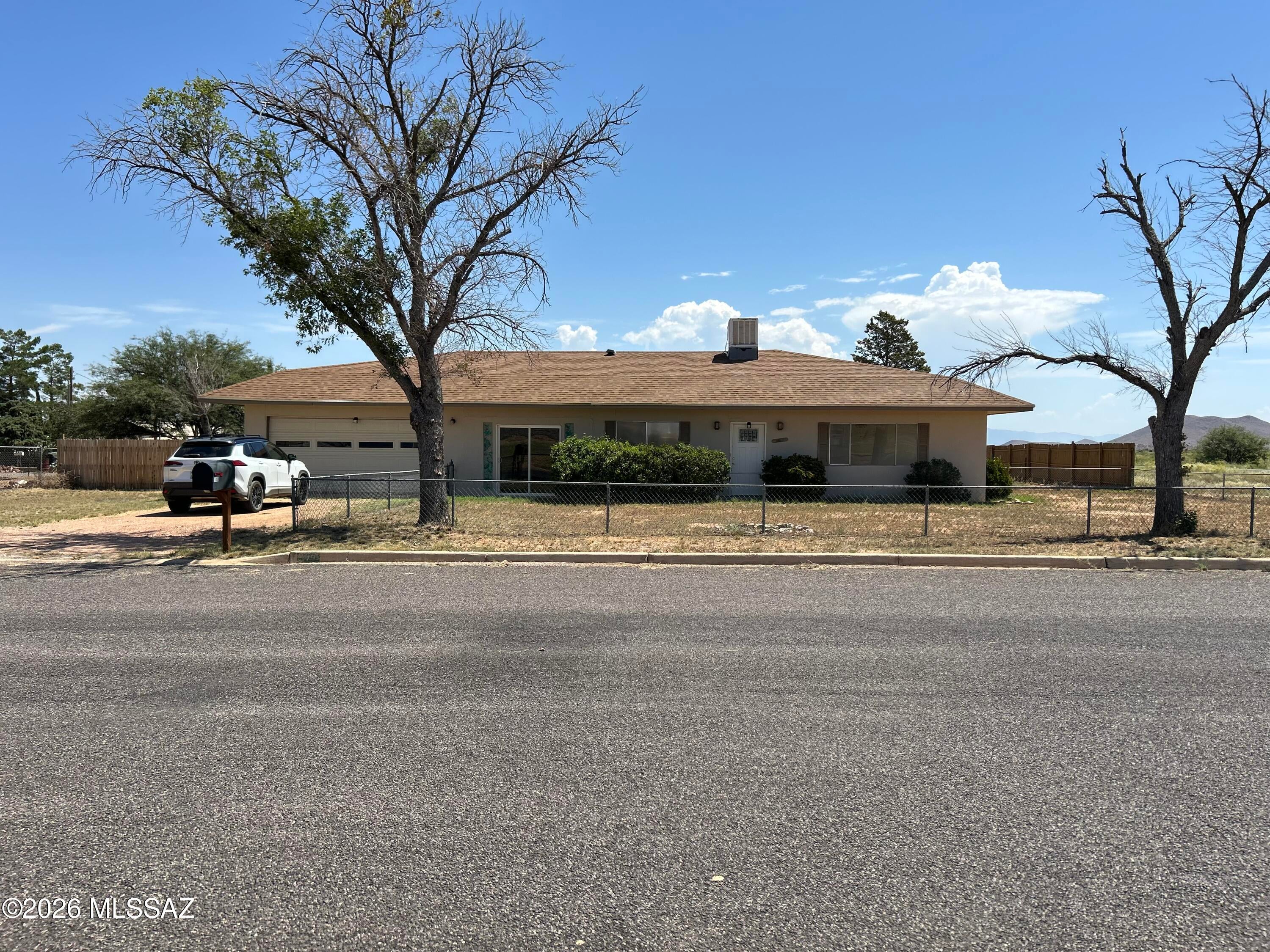 This corner lot is just over half of an acre. It is surrounded by chain link and wood fencing.  There is room on this spacious lot for a Work Shop or  a swimming pool.  There are great mountain views from the living room.  Fiber Optic internet is available. All hard surface flooring throughout. (mainly tile).  There is a bonus room between the garage and kitchen areas that does not currently have heating or cooling.  This home has Evaporative Air Cooling and Baseboard Heating.  There is a septic system and water is provided by Hope Water Co.  The SPUDS identifies some of the repairs that may be necessary.