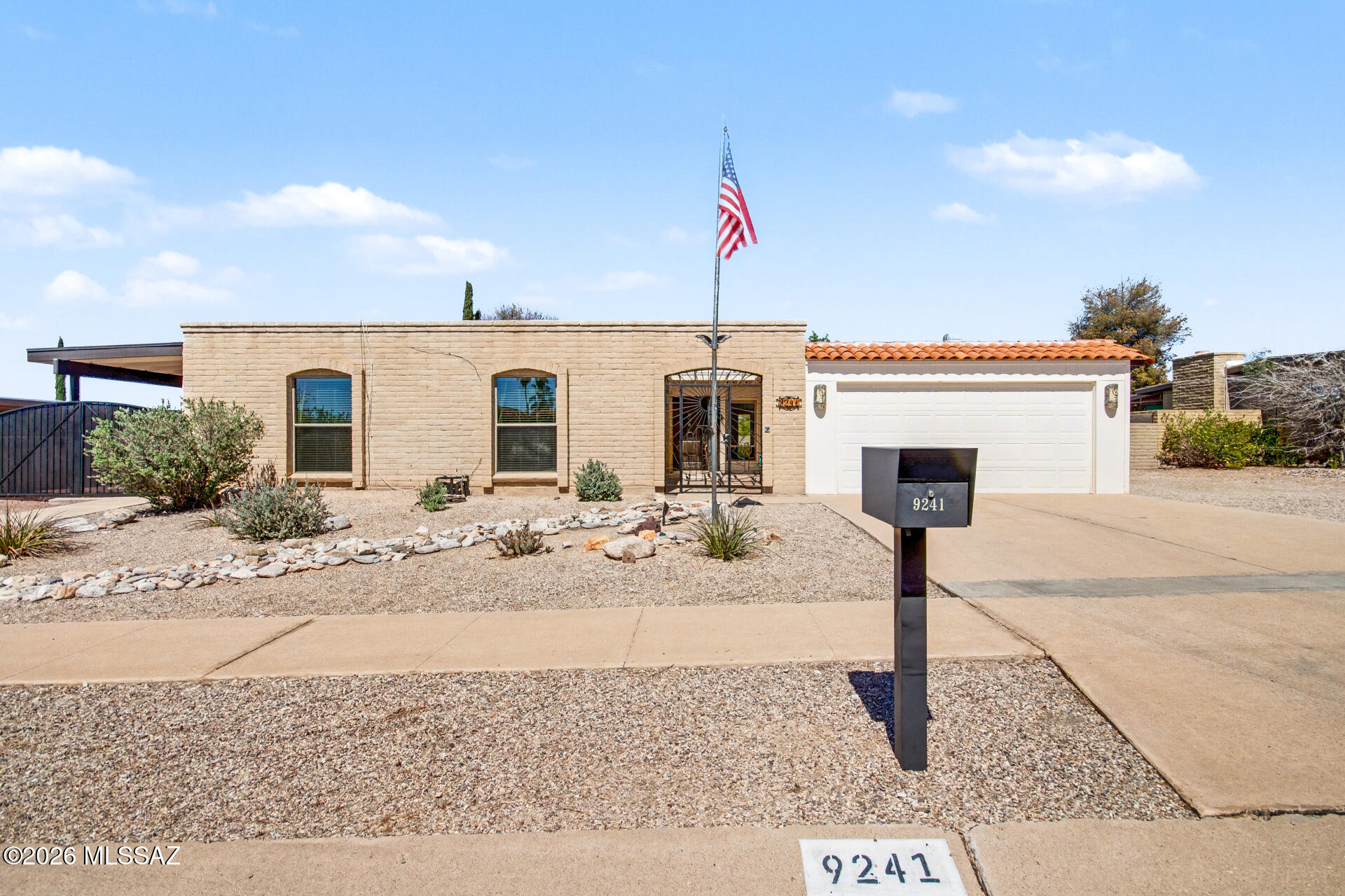 Welcome to this inviting home showcasing stunning mountain views and a solar-heated pool--perfect for year-round enjoyment! Desert landscaping, 2-car garage & 1-car carport set the stage. Enter through a gated courtyard & custom door into a bright interior with neutral tones & classic Saltillo tile. The living/dining area opens to the patio for easy indoor-outdoor living, while the family room features a cozy wood-burning fireplace. The upgraded kitchen offers exquisite custom cabinetry throughout home, granite counters, tile backsplash. Bonus room with backyard access adds flexibility. The primary suite includes a walk-in closet, custom built-in make-up vanity with mirror, bidet & oversized shower. disability ramps throughout. Enjoy a solar-heated pool, covered patio & private desert oasi