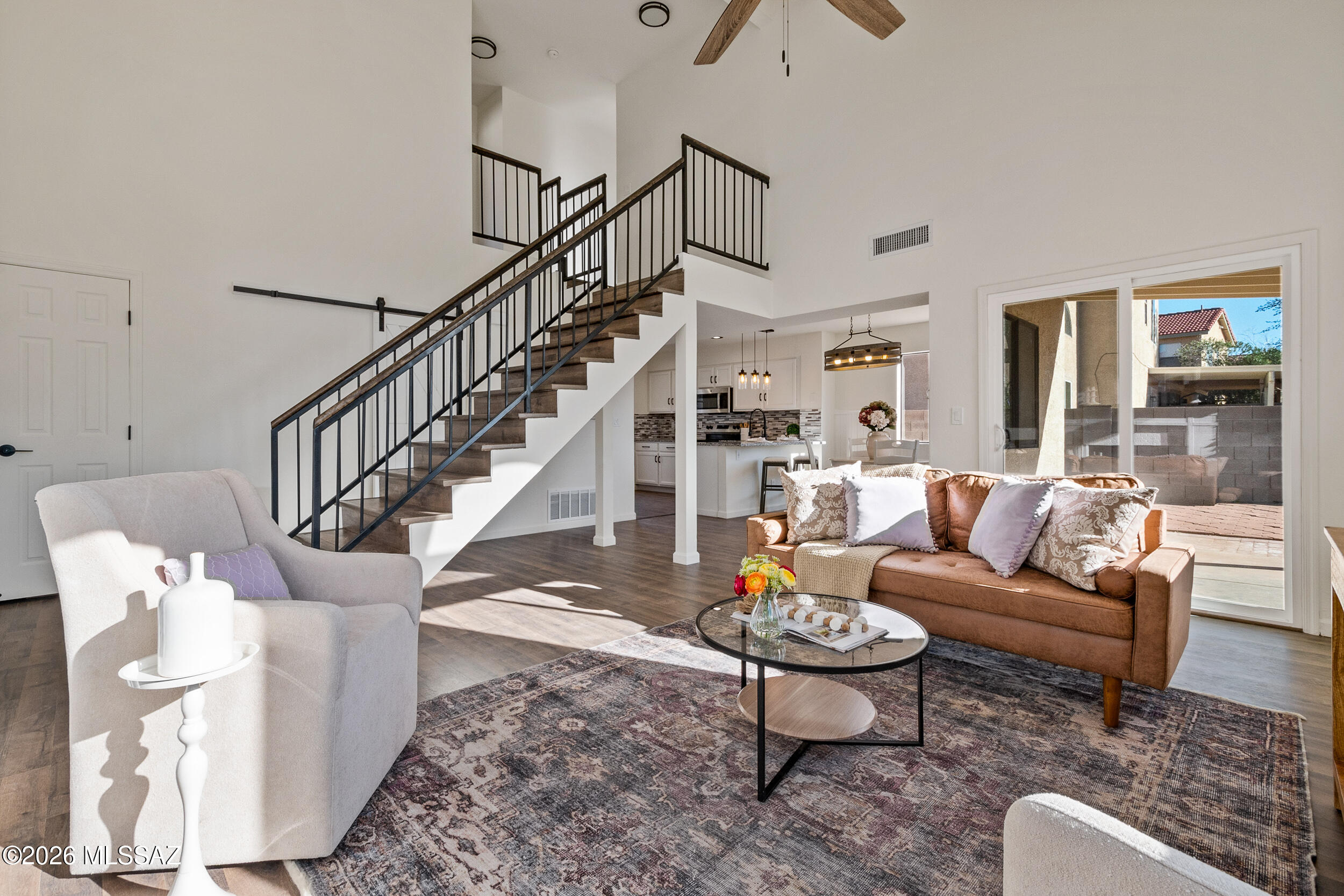 Bathed in natural light and thoughtfully reimagined, this beautifully remodeled home welcomes you with an airy, open feel and timeless modern charm. Wide-plank flooring flows seamlessly throughout, setting a warm and cohesive tone, while fresh neutral finishes create a bright, inviting atmosphere. The living space feels both grand and comfortable, anchored by a striking fireplace that adds character and a cozy focal point--perfect for relaxed evenings or effortless entertaining.
The heart of the home is the stylish kitchen, where crisp white cabinetry, sleek finishes, and generous counter space come together to create a space that's as functional as it is beautiful. Bar seating invites casual meals and conversation, making it easy to stay connected while hosting.
