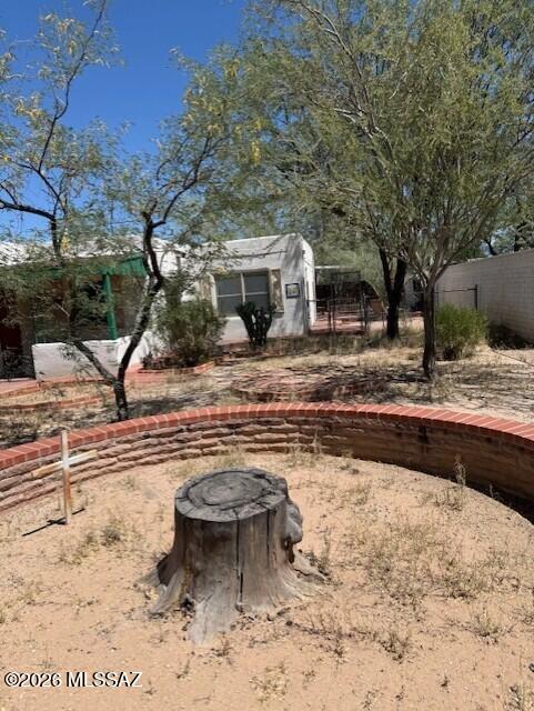 This property has lots of possibilities.  Zoning is R2, so you can build another home on the property.  Buiild a new home in fronlt of this home and rent this home out or remodel and update this existing home for a small family.  Home is close to all amenities including The botanical gardens and the U of A.  Priced to sell quickly.