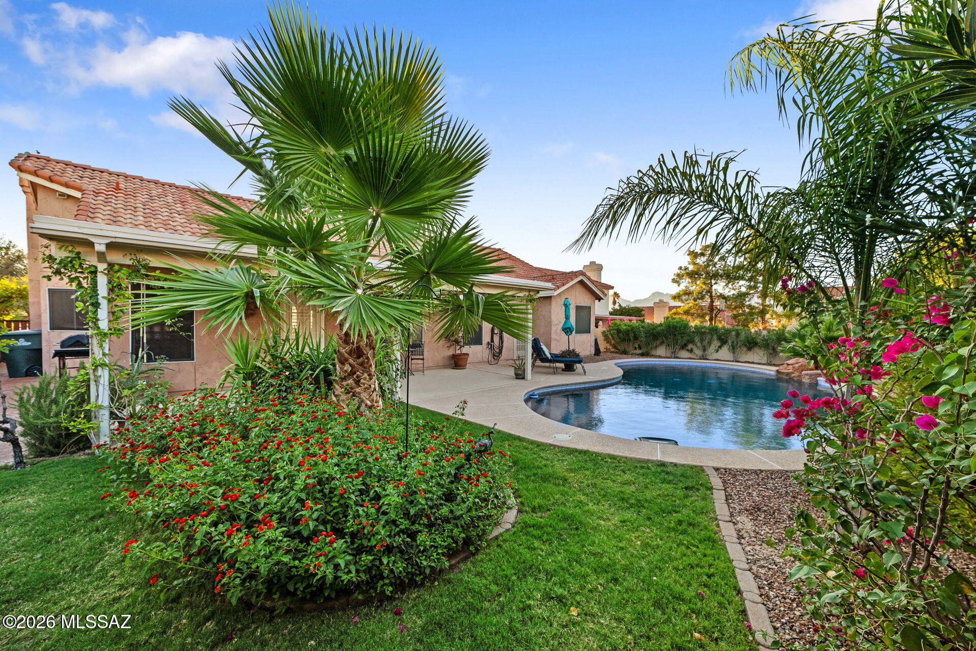 A rare opportunity in sought after Richmond Place, this impeccably maintained single story residence showcases exceptional pride of ownership. Framed by breathtaking Rincon Mountain views, the home blends refined comfort with effortless indoor-outdoor living. Rich travertine flooring and an updated kitchen featuring new countertops and sink, premium stainless steel appliances, gas range with double ovens, and a large breakfast bar create an inviting space for everyday living and entertaining. The serene primary retreat offers direct access to the pebble tec pool, a walk-in closet, dual vanities, a soaking tub and separate shower. Outside lush landscaping, mature palms, grass, pavers, a covered patio, and pergola create a private backyard oasis. New roof installed June 2026, no poly pipes!