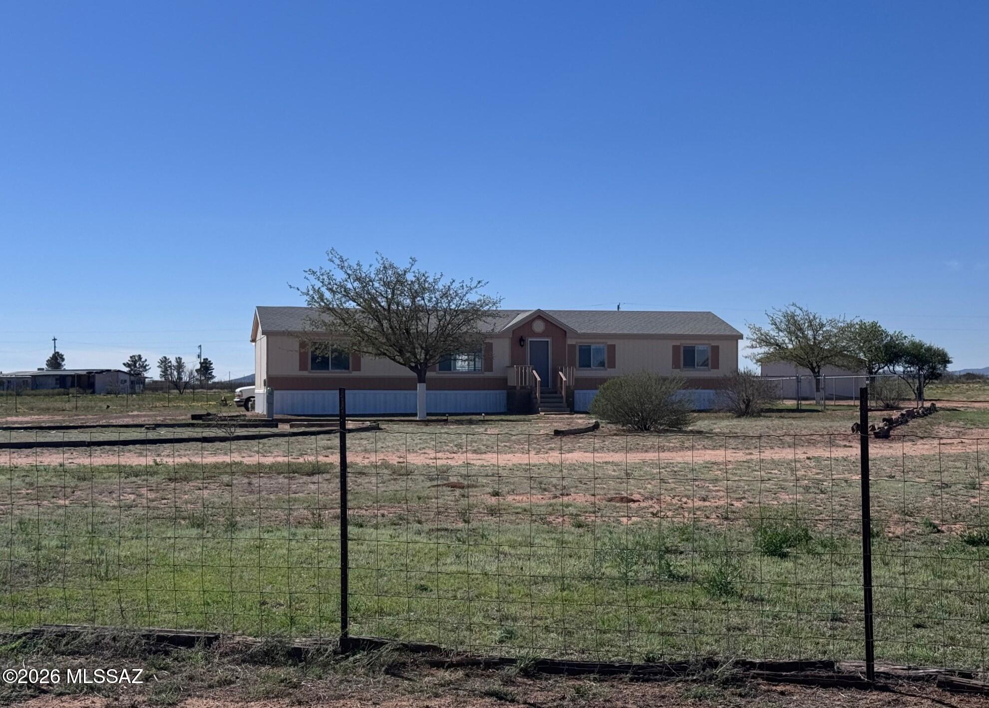 Beautifully set up horse property, fully fenced & cross-fenced, featuring a four-stall horse barn, tack room, 2-story hay barn and additional pole barn-ideal for equestrian use or a small ranch operation. The property consists of two parcels totaling just over 9 acres offering flexibility & space. The beautiful updated main home consists of 4 BR-2 BA with a covered rear deck to enjoy the outdoors. There's a 2 BR-1 BA updated guest house or potential rental with it's own electric, gas & private entrance. Additional improvements include a detached garage, large carport, & RV storage. The larger parcel includes two residences ready for your vision & updates. A tractor with implements also available, making this a great opportunity to create a fully functional horse property or rural retreat. The property has 3 wells with one supplying the main house and Singlewide. That well registration is 55-621339. The other 2 are; 
55-611934 & 55-555398.