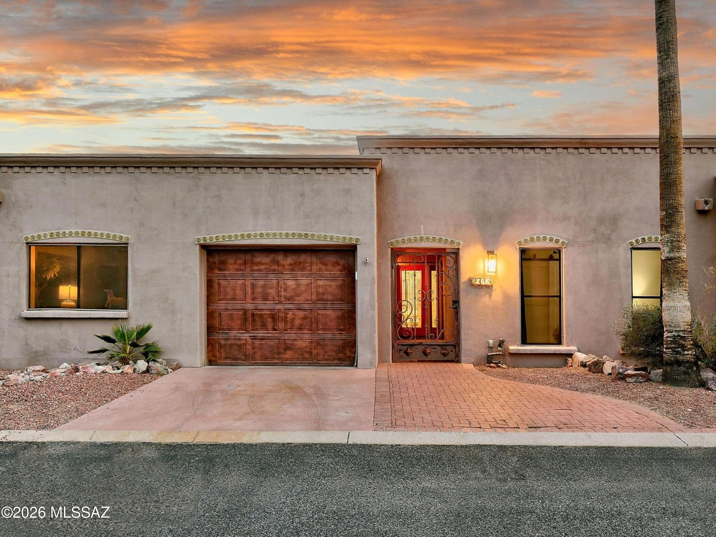 Stunning beautifully remodeled end unit -townhouse overlooking the 14th fairway of the prestigious gated OMNI Tucson National Golf Club. A privately gated front courtyard, exquisite Great room with walls of windows and French doors, lovely dining area, sophisticated gourmet kitchen with granite countertops, designer backsplash, custom cabinets, incredible gas range with dramatic glass lighted hood, stainless steel appliances, travertine tile floors throughout (no carpet),  3 bedrooms ( split plan), 2 baths including primary suite with sitting area, luxurious updated bath with granite countertops, double vanities, Jetted tub, large walk-in closet and private entry to the rear patio. Laundry room with washer & dryer and oversized one car garage w/storage room. Enjoy the fabulous large backyard with covered brick paver patio, Char-Broil Medallion outdoor kitchen with bar area, granite countertops, built-in-barbeque, refrigerator and sink, lush landscaping, gorgeous mature trees and great walking path to the golf course plus the sensational community pool & spa. Move right in!!!