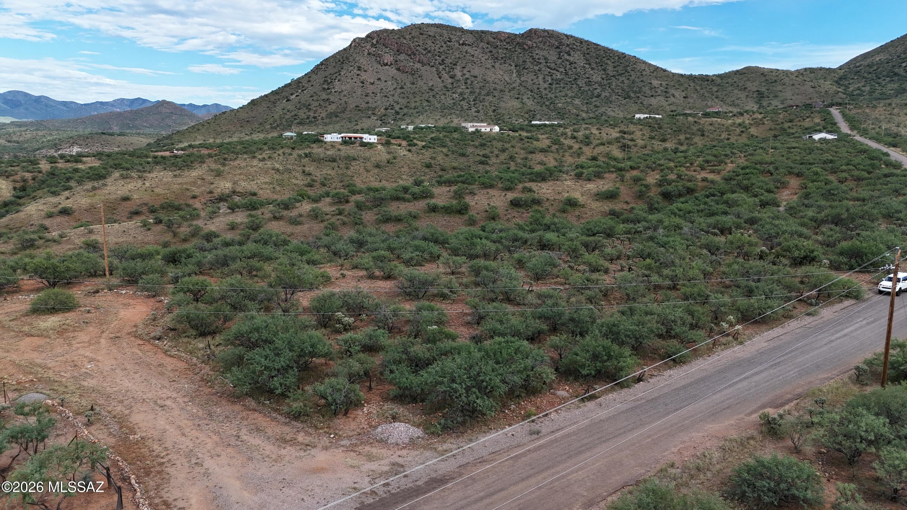 Nice nearly flat corner lot with mountain views in all directions.
Power poles at the street.  The water verification letter should be coming back any time now, when it does I will upload it in the documents tab.