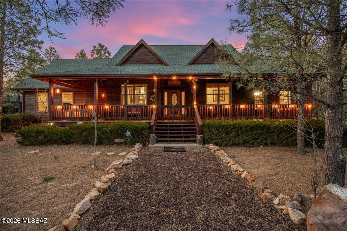 At approximately 6,612 feet elevation, this 3 bedroom, 2 bathroom home sits on 1.56 acres at the end of a cul-de-sac in a homes-only neighborhood. What sets this property apart is the privacy--set back in a quiet area surrounded by mature Ponderosa pines with frequent visits from deer and elk. Horses are allowed and there is no HOA. The home also features a new roof, adding value and peace of mind. As you enter, a dining room and office are located off to the right. The main living area offers vaulted pine ceilings, a wood-burning fireplace, and an open layout connecting the living room and kitchen. The kitchen is large, functional, and well laid out with granite countertops, updated appliances, ample cabinetry, and dual sinks. The primary suite is located on the main level and includes vaulted ceilings and a bathroom with dual sinks, a soaking tub, separate shower, and private toilet area. Upstairs provides additional space with a loft, offering flexibility for guests, office, or recreation. A vented skylight helps regulate temperature during warmer months. Exterior features include covered front and back decks with composite decking, a stamped concrete patio, and an in-ground fire pit. The backyard is fenced with a lawn area, garden space, and mature trees, making it suitable for pets. The entire parcel is enclosed with a three-rail fence and offers multiple access points. Additional improvements include a two-car attached garage and a 12x30 detached storage building with power, roll-up door, workbench, and loft storage. This property offers a quiet setting with space, functionality, and flexible living options.