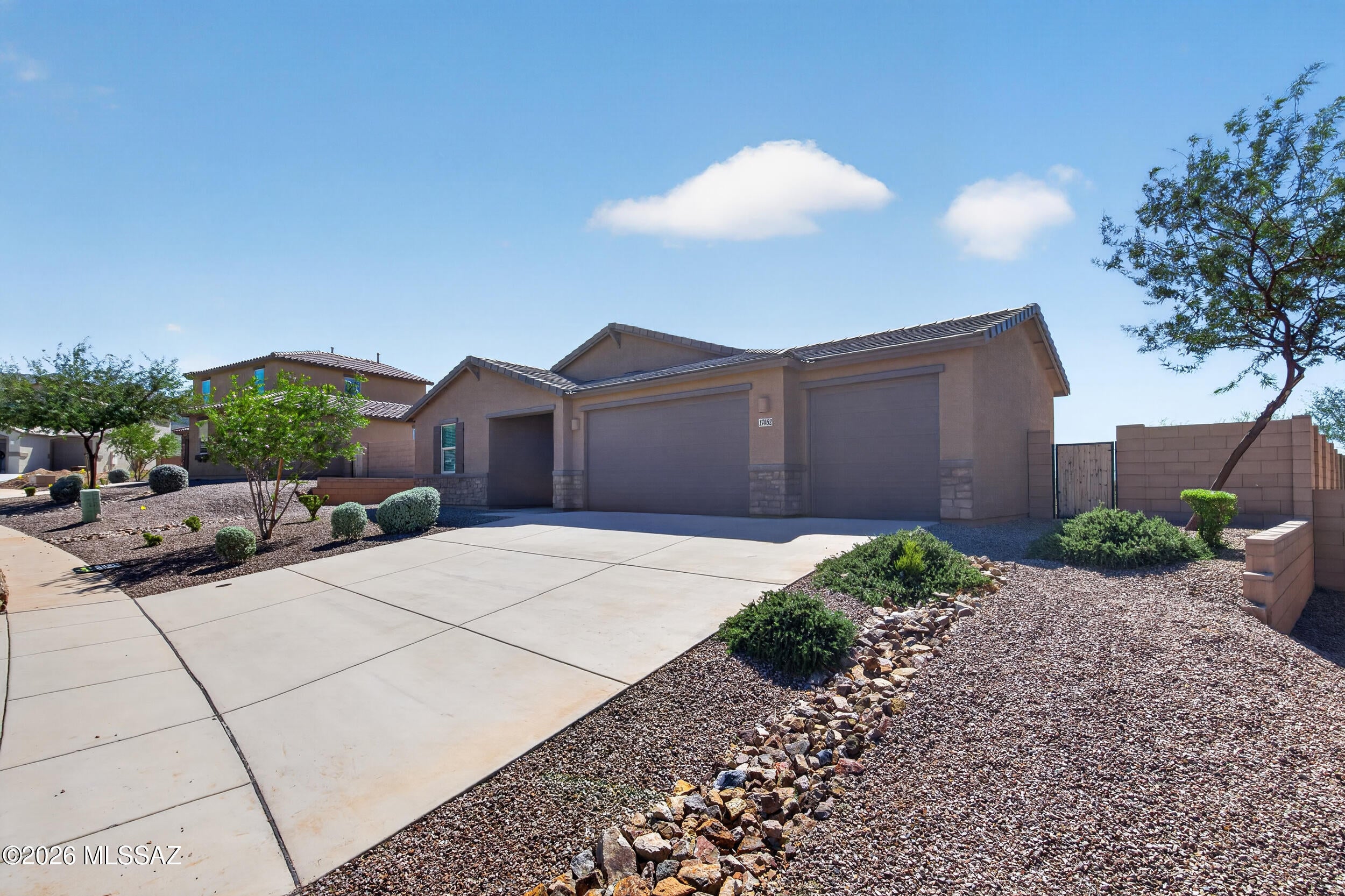 Former model home with a 4 car garage in Santa Rita Ranch, Vail, AZ! Built in 2023, this 4 bedroom home backs to open space with no rear neighbors, so your view is all desert and sky. Inside, enjoy an open floor plan with recessed lighting, neutral paint, wood look ceramic tile, and carpet in every bedroom. The kitchen has granite countertops, a large center island, and stainless steel appliances, and the 4 car garage has room for cars, desert toys, or a workshop. Santa Rita Ranch offers a community park with a playground, baseball field, basketball court, and walking trail. You're in the Vail School District, close to Interstate 10 for an easy Tucson commute, and near the Santa Rita Mountains for weekend hikes.