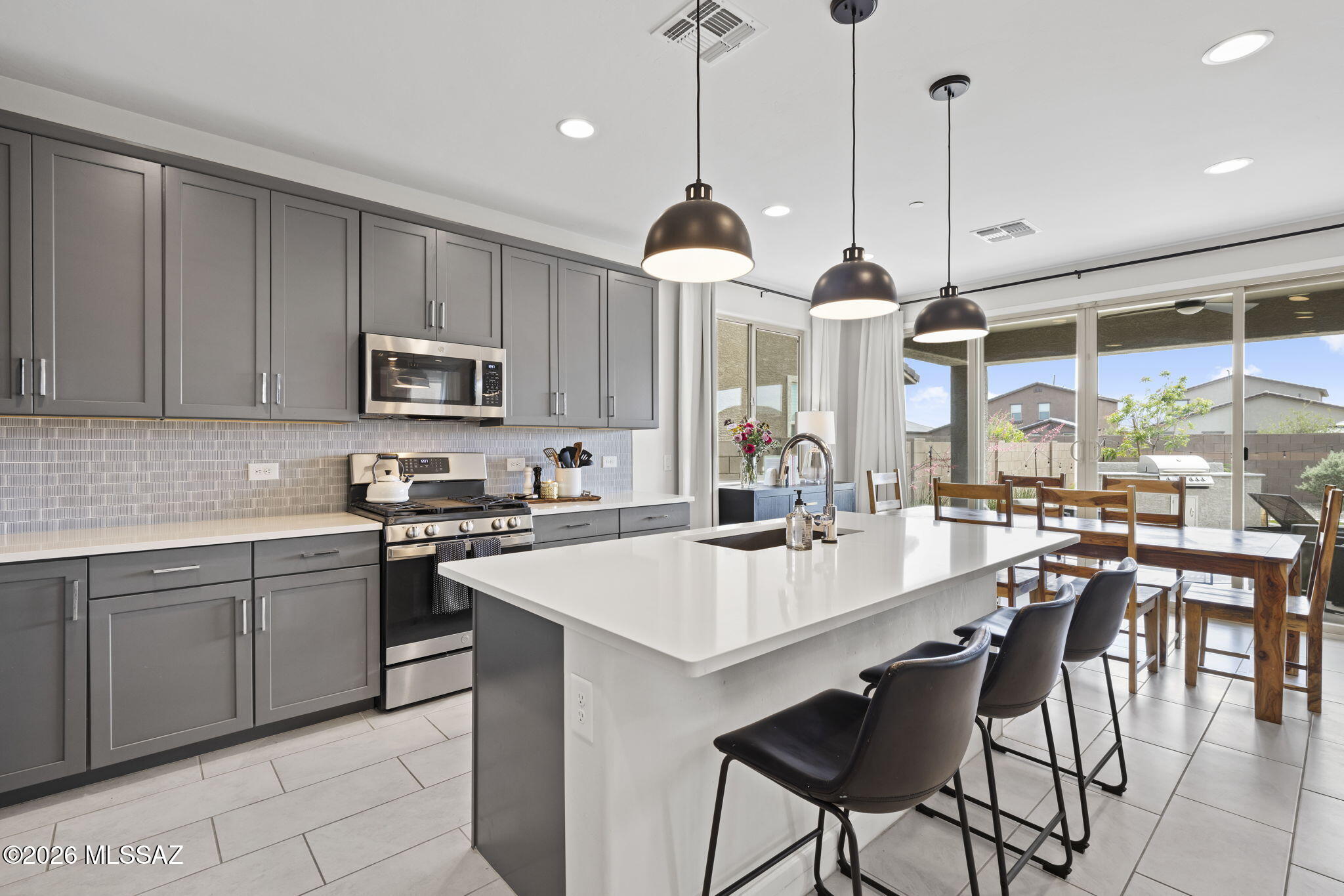 This stunning former builder model is loaded with luxury upgrades on a spacious lot! This 4 bedroom home with open office/den, & 2 1/2 bathroom home features an airy loft with mountain views. Upgraded kitchen w/full backsplash, all appliances, and designer touches. Enjoy a gas fireplace perfect for ambiance and entertaining. Backyard is an entertainer's dream with built-in BBQ, large turf area, full extended patio, and beautifully landscaped grounds. New Marana Aquatic Center, Tangerine Farms K-8 School and the community dog park offering the best of convenience and lifestyle has to offer.  Seller will consider pets. Call today for a showing!