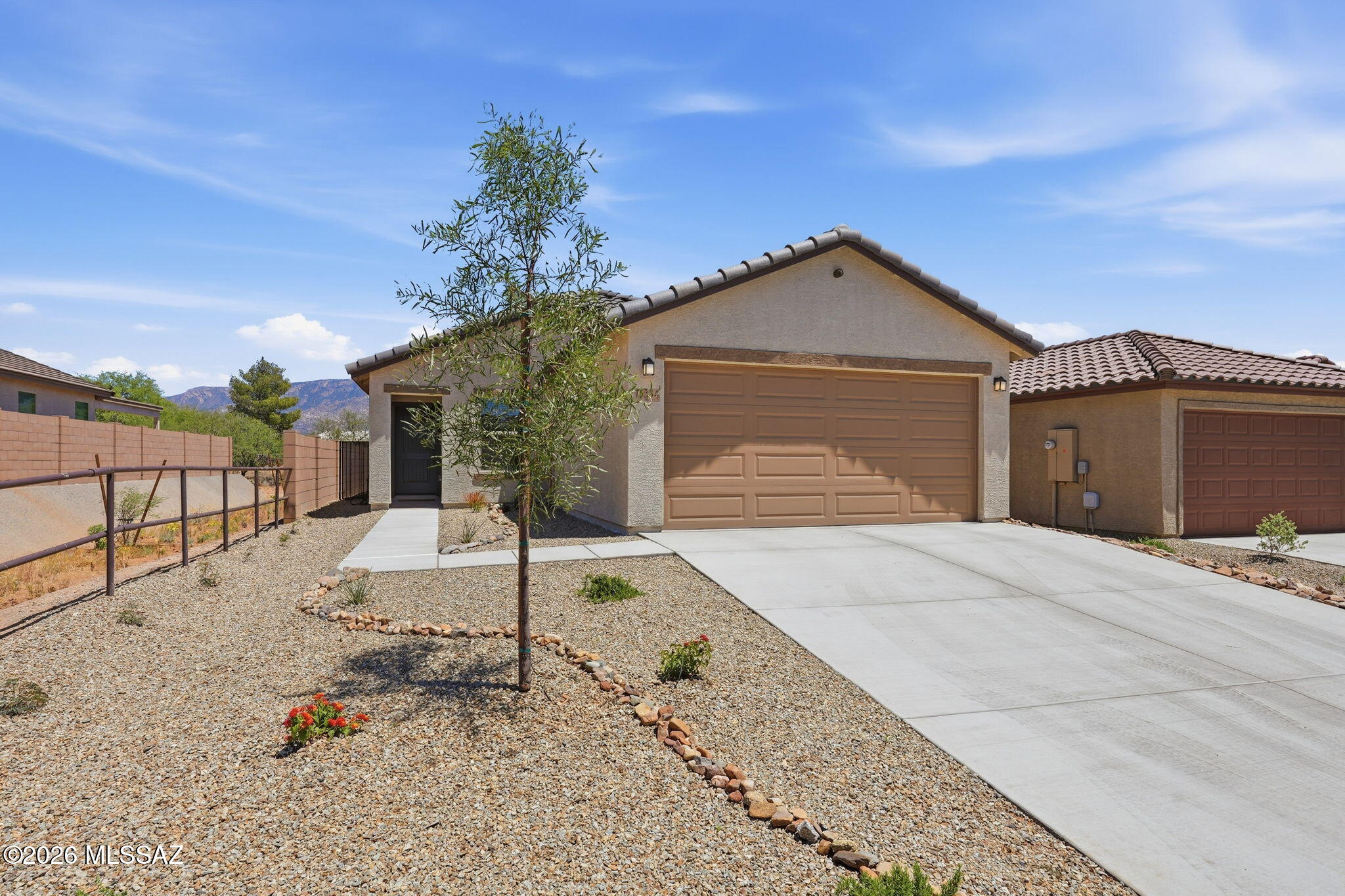 Why wait to build when you can move into this pristine, 3BD/2BA (1,465) 2025-built residence in the highly sought-after Wildflower Reserve! This modern single-story home offers the perfect blend of efficiency and contemporary style, positioned within a community celebrated for its wide-open spaces and spectacular views of the Santa Catalina Mountains. Step inside to discover an inviting open-concept floor plan that maximizes every square foot. The heart of the home is a bright, airy Great Room that flows seamlessly into a gourmet kitchen, complete with professional-grade stainless steel appliances, elegant granite countertops, and a functional center island that's perfect for casual mornings or holiday hosting. Durable, stylish flooring and high-end cabinetry give the home a sophisticated, move-in-ready feel from day one. The primary suite serves as a quiet sanctuary, offering a spacious walk-in closet and a spa-inspired bathroom with dual vanities and a luxury glass-enclosed shower. Two additional guest rooms provide the flexibility you need for a growing family, a hobby room, or a dedicated home office to take advantage of the quiet, serene surroundings. Outdoor living is a breeze with a covered rear patio, a perfect spot for evening stargazing or enjoying a quiet sunrise. Just minutes away, you'll find community parks, walking trails, and premium shopping at the Oro Valley Marketplace, plus easy access to hiking at Catalina State Park.