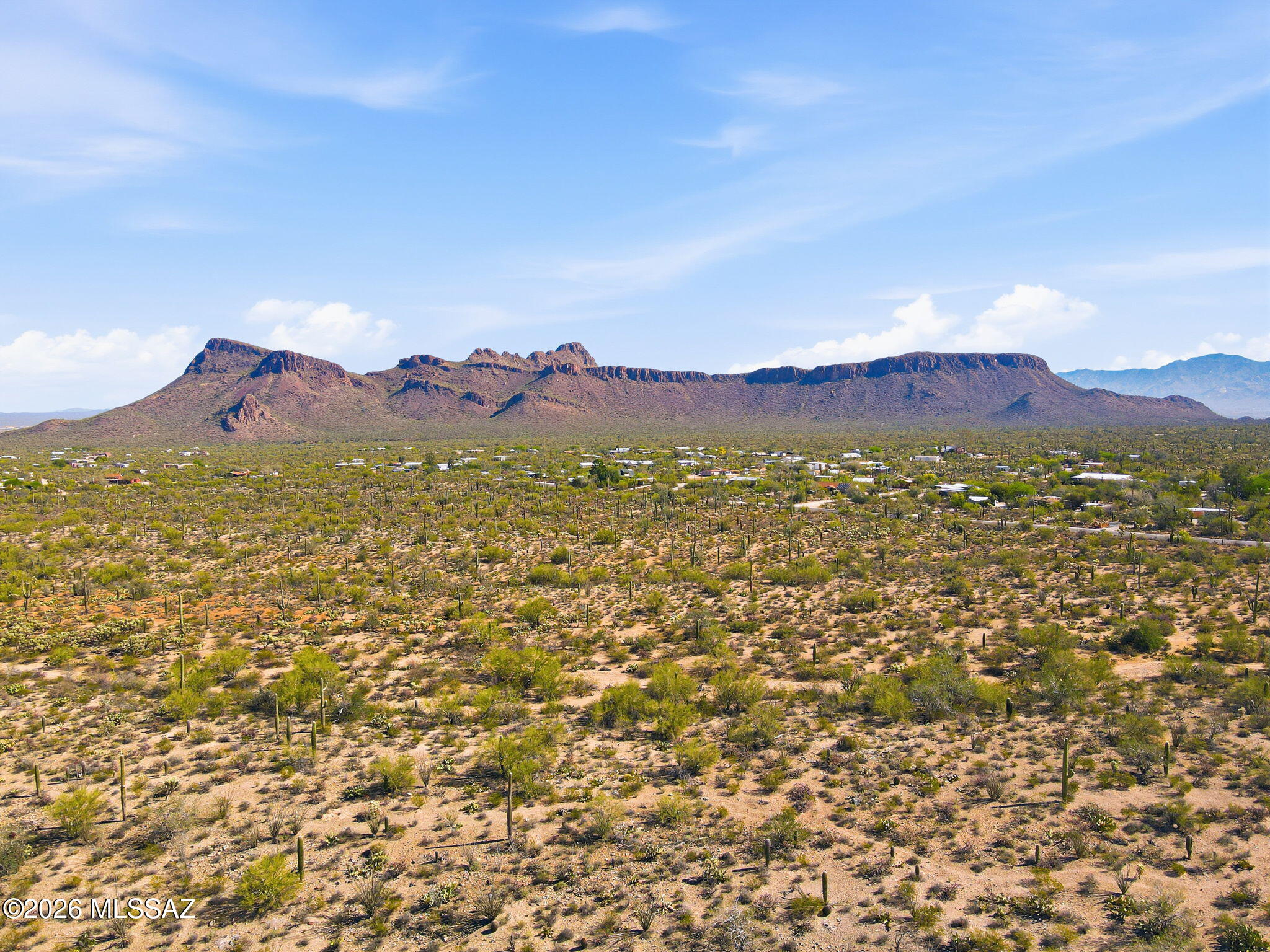 NEW CUSTOM LOT SUBDIVISION of 1+ acre lots: all with PANORAMIC mountain views. LUSH vegetation dotted with SAGUAROS and LEVEL or GENTLY SLOPED building areas. Choose RIDGETOP sites with views across Avra Valley, and the peaks of NEARBY Saguaro National Park or nestle in flat, well vegetated sites for PRIVACY.  Only 11, Phase 1 parcels available, priced from $148,000 to $164,000. Sites serviced by water, electric, phone and cable with HOA fees of only $125 per year. Single level homes required with a minimum 1800 sq. ft. and 20'  height restriction.   Choose your builder or ask about the available Dell Mar Homes models. Approx. 13 minutes west of the Ina/I-10 intersection for convenient Downtown, U of A and Airport access. Shown by appointment only during construction. CALL TODAY.