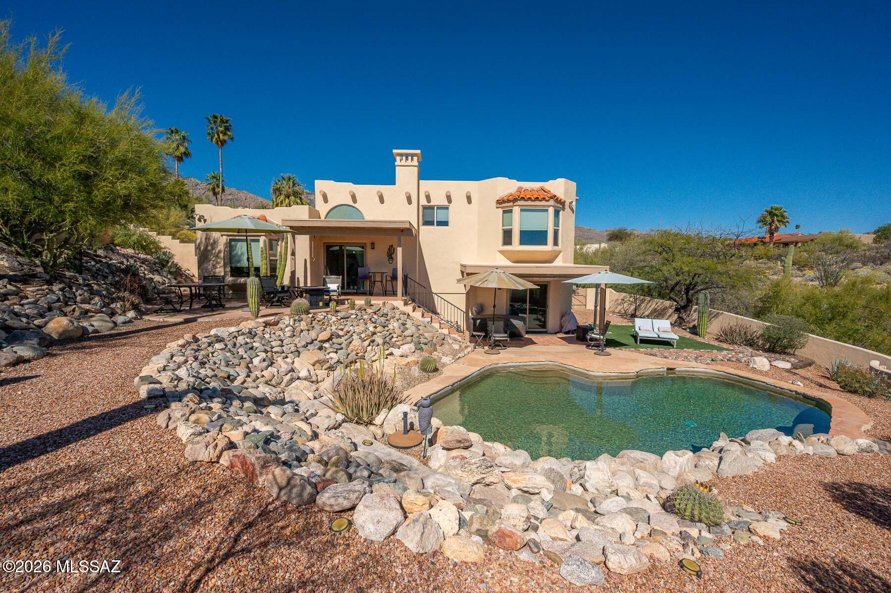 Spacious 5-bedroom, 3.5-bath home located in the Foothills offering comfortable living and great outdoor space. This home features both a living room and family room, providing plenty of space for entertaining and everyday living. The open kitchen includes a large island and breakfast nook, creating a welcoming space for cooking and gathering.
Step outside to enjoy a covered back patio overlooking a sparkling pool, perfect for relaxing or entertaining guests. The property is beautifully enhanced with desert landscaping in both the front and backyard, offering low-maintenance curb appeal and classic Arizona charm.