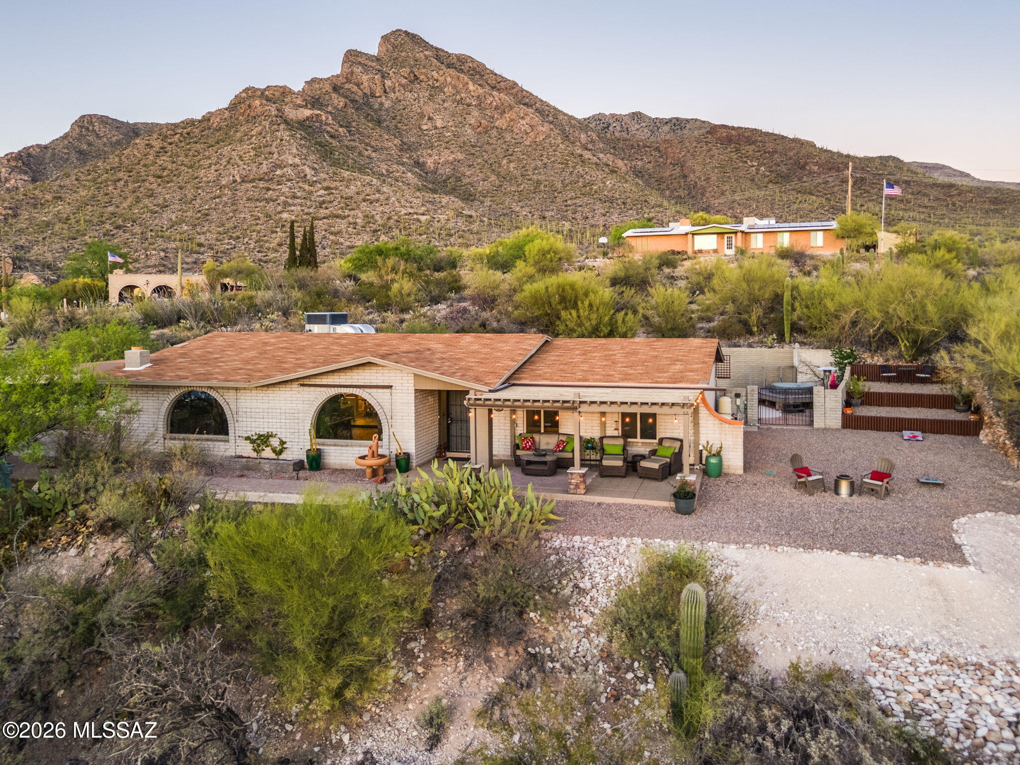 Nestled at the base of majestic Pusch Ridge, this stunning Rancho Catalina home delivers the rare combination of total privacy & unbeatable convenience. Breathtaking 360° views stretch in every direction. Spend evenings on the gorgeous covered front patio as the sky blows up with the color of amazing sunsets over the city lights below. Unwind or entertain in your own backyard oasis, complete with sparkling pool & hot tub. Inside, a spacious great room anchored by a classic beehive fireplace sets a warm, inviting tone, while the newly remodeled kitchen & bathrooms bring fresh, classic style to this timeless 2004 sq ft retreat. 3 bedrooms, 2 baths, & all the best of Oro Valley just minutes away, shopping , dining, & top amenities- yet it feels like a world apart. Owner/Agent