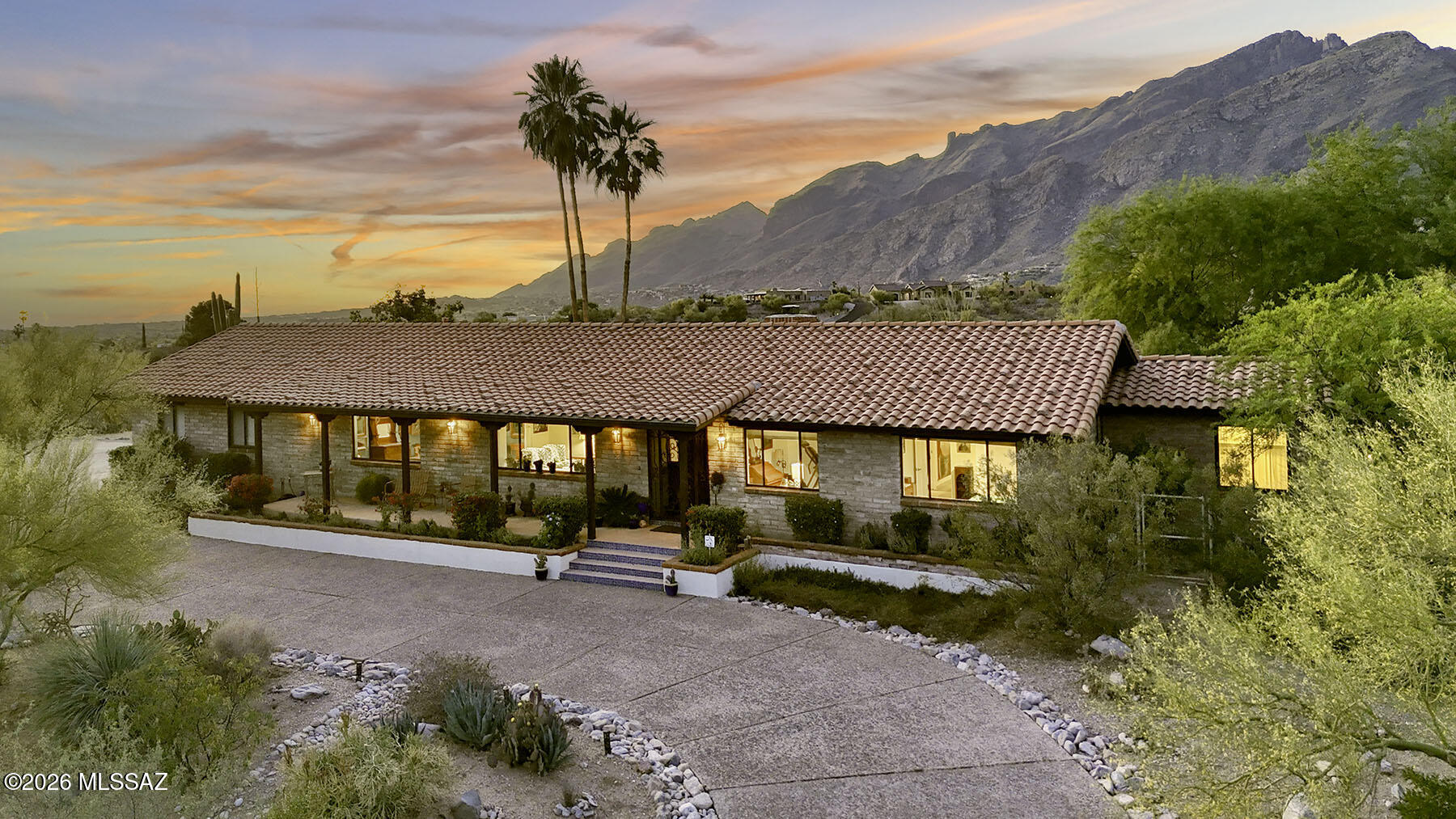 Catalina Foothills View Retreat - Fully Renovated Burnt Adobe Ranch!  Located high on a quiet cul-de-sac in the coveted Catalina Foothills, this classic burnt adobe ranch home captures the essence of Tucson living. Spanning 3,058 sq. ft., the residence offers 4 bedrooms and 3 baths, with breathtaking panoramic city views from the expansive front porch and unobstructed Catalina Mountain vistas from the backyard oasis.  Set among abundant Upper Sonoran Desert vegetation including majestic saguaros, ocotillo, jojoba, desert willows, and agave, the property blends natural beauty with refined comfort.  Beginning in 2015 and extensively renovated over the following year, this home has been thoughtfully reimagined from top to bottom. Major upgrades include: replacement of the original cedar shake roof with durable cement mission tile; fully updated electrical and plumbing systems; completely remodeled kitchen with repositioned island and updated appliances (including a recently replaced refrigerator); renovated bathrooms, plus the addition of a spacious primary bath; newer and updated HVAC systems, including a newer east unit and heat pump; raised ceilings in select areas and added storage space; custom cantera fireplace and hearth in the family room; custom hardwood entry door with seeded glass sidelights and upgraded security door; California Closets-designed storage solutions; updated garage door and system; a separate water heater serves the primary suite for added comfort.  Outdoor living shines just as brightly. The pool and patio area were redesigned to create a private retreat, complemented by lush landscaping, irrigation upgrades, and fragrant star jasmine vines that attract nesting finches year after year.  Meticulously maintained with annual termite inspections and comprehensive documentation for all improvements, this home reflects pride of ownership throughout.  From unforgettable sunrises to peaceful evenings under the stars, this is a place where lasting memories are made. Now ready for its next chapter, this exceptional property offers a rare opportunity to own a truly turnkey home in one of Tucson's most desirable settings, and in the Catalina Foothills School District #16.