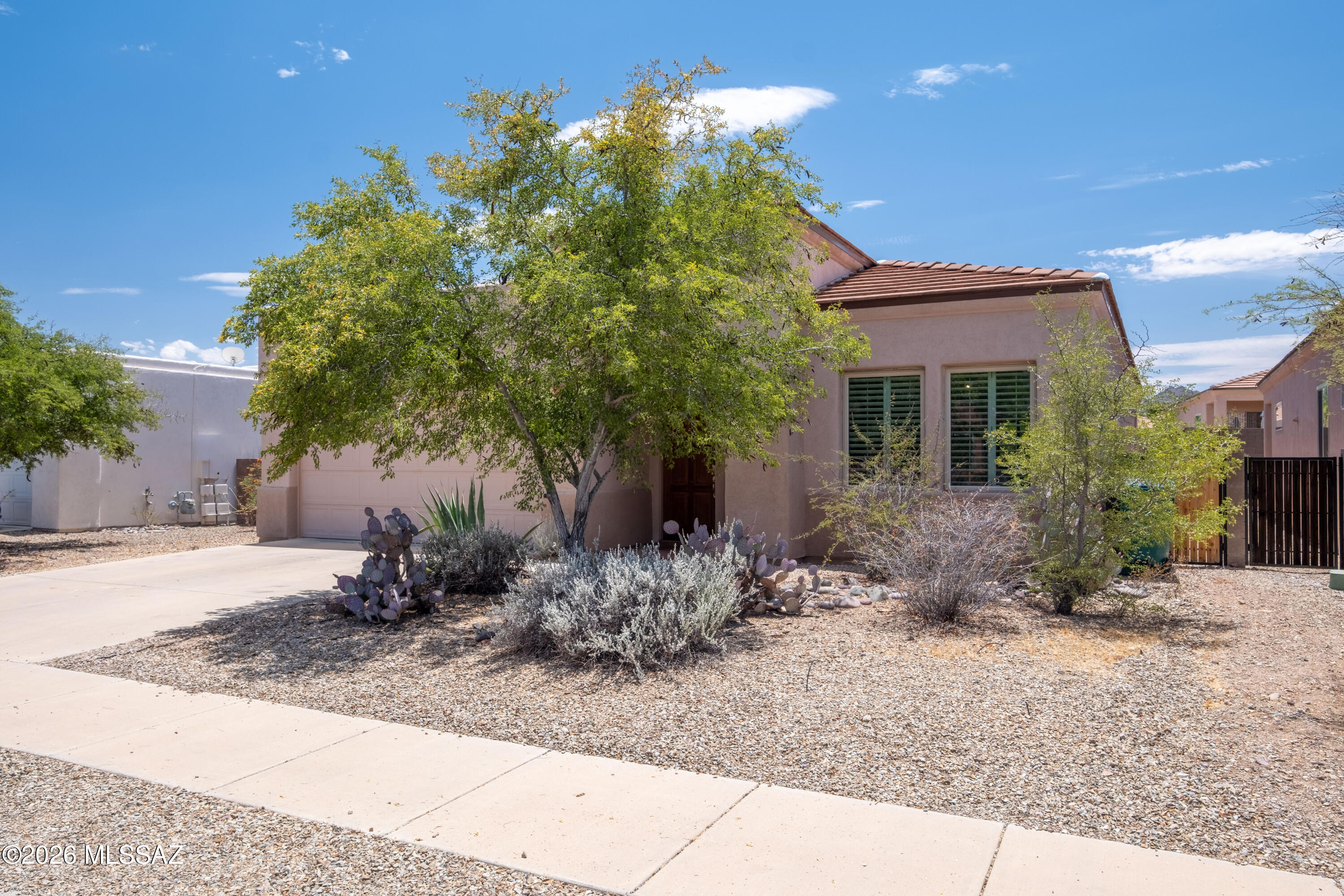 Peace and tranquility await you, just moments outside of Tucson.  Convenient to some of the best hiking and biking trails in Tucson, this 3 bedroom 2 bath home is situated in the Ranch Agua Dulce community, a World Wildlife Federation neighborhood.  The interior is in excellent condtiion also featuring a brand new refrigerator and dishwasher.  High ceilings, saltillo tile throughout the main living areas and primary suite, and the high-quality carpeting in the auxilliary bedrooms make this home feel very luxurious.  Many recent upgrades.  Seller has been very diligent on maintaining the home and has invested in upgrades every year.  Community features a heated pool and playground.