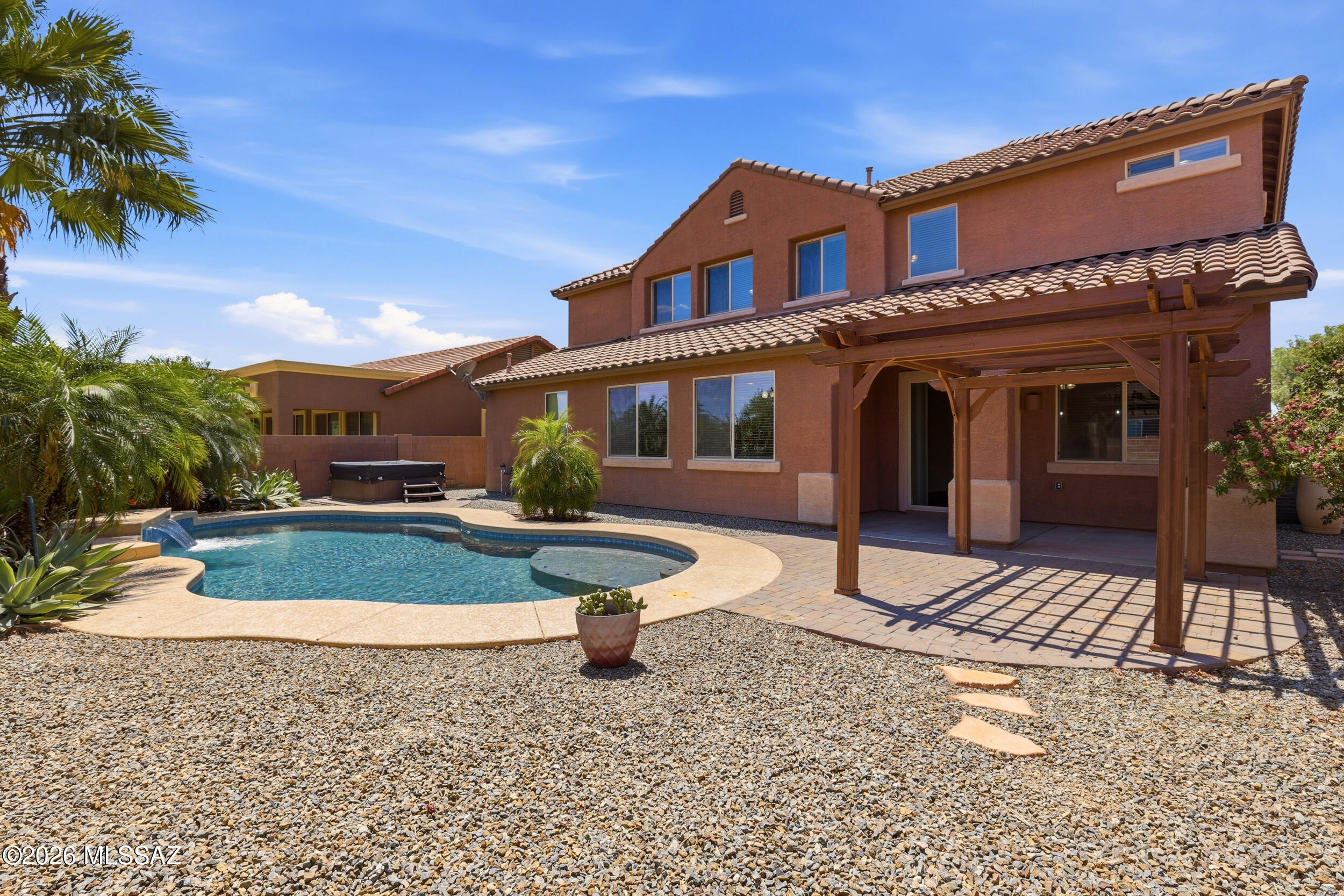 Stunning move-in ready 5BR/4BA pool home in gated Tangerine Crossing! Freshly painted interior throughout--including baseboards & doors--with brand new carpet upstairs. 3,664 sqft contemporary two-story built 2014 features open great room, formal dining, gourmet kitchen with light granite, walk-in pantry, gas cooktop & stainless appliances. Versatile upstairs loft, rec room & sitting room. Luxurious primary suite with granite double vanity. Resort-style backyard: sparkling saltwater pool, hot tub, covered patio. 3-car garage, energy-efficient lighting. Gated community with park & sidewalks, low $260/qtr HOA. Top Marana Schools--Dove Mountain CSTEM K-8 & Mountain View HS. Close to Dove Mountain, golf, hiking & dining!