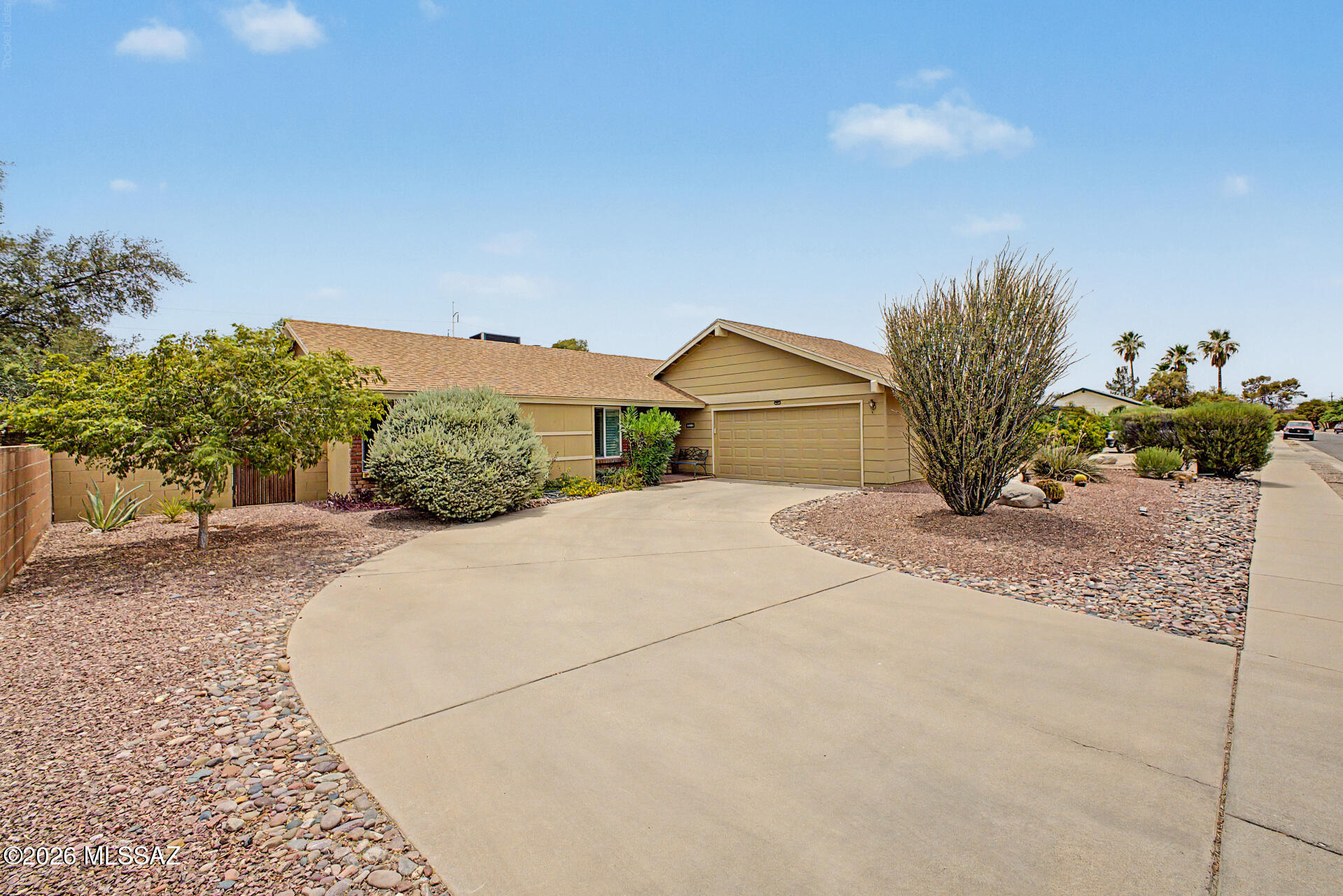 Charming home in Flowing Wells featuring 3 bedrooms is what you've been looking for! Step inside to find an open layout filled with natural light and enhanced by vaulted ceilings. The inviting living area has a cozy fireplace, while the dining room's French doors create a seamless transition to the outdoors. The kitchen is equipped with recessed lighting, mosaic tile backsplash, granite countertops, a peninsula, and stainless steel appliances. The primary suite offers patio access, a closet, and a full bathroom. Enjoy relaxing in the backyard, complete with a covered patio, pavers, and lush greenery. A sizable shed is ideal for an office/hobby room or as a storage room. Don't miss this wonderful opportunity, conveniently located near Tucson Mall, restaurants, entertainment, and more!