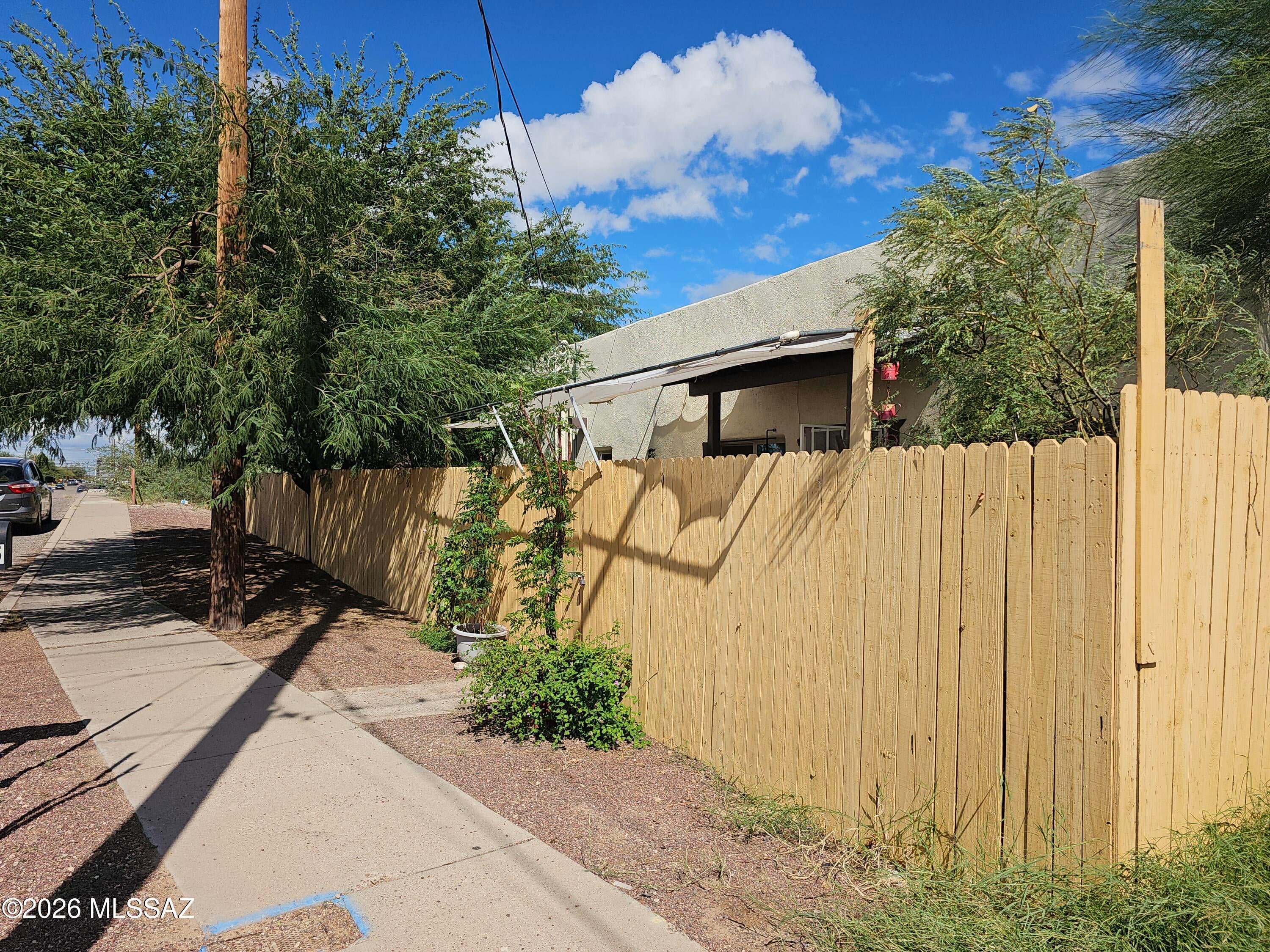 Discover the charm of South Tucson in this inviting 1946 adobe home featuring 3 bedrooms and 1 bathroom - an ideal starter home. Enjoy direct access to the multiuse path for cyclists and pedestrians, El Paso and Southwestern Greenway. A Mountain views, walkability to Mission View Elementary, and less than a 10-minute drive to Downtown. Mature citrus trees, established mesquite, and a private yard create a tranquil retreat. The outdoor gathering area with a built-in grill is perfect for entertaining and enjoying Tucson's outdoor lifestyle. Three sheds, two detached and one attached, offer ample storage for tools, hobbies, and equipment. Conveniently located near traditional favorites and newer dining destinations, this home blends historic character, privacy and accessibility.